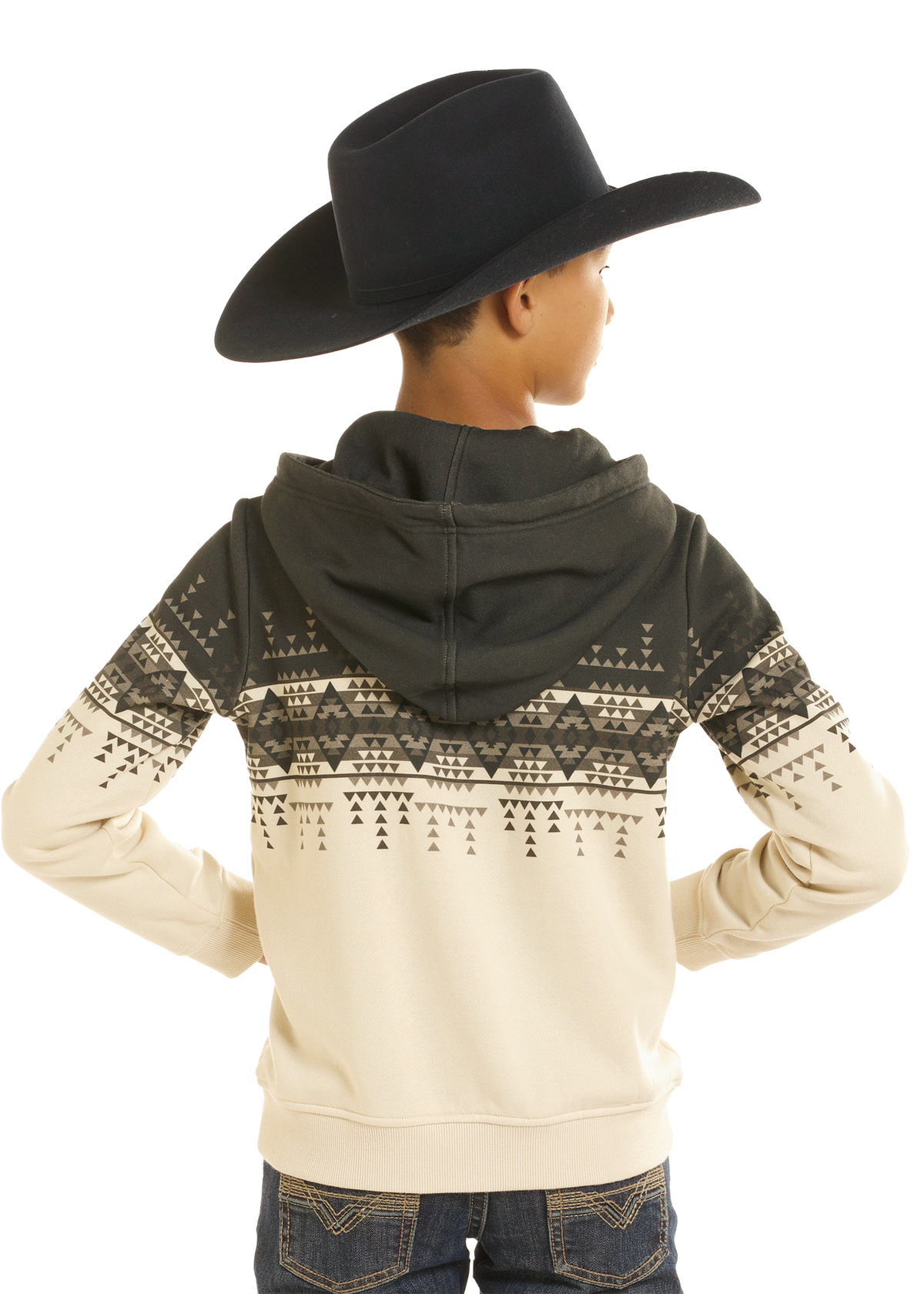 A child shown from the back wearing a black cowboy hat, a cream and black patterned hoodie, and blue jeans against a plain white background.