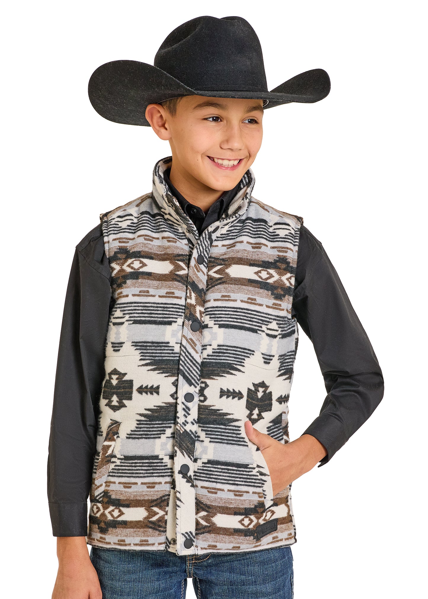 Child wearing a patterned vest and black cowboy hat on a white background