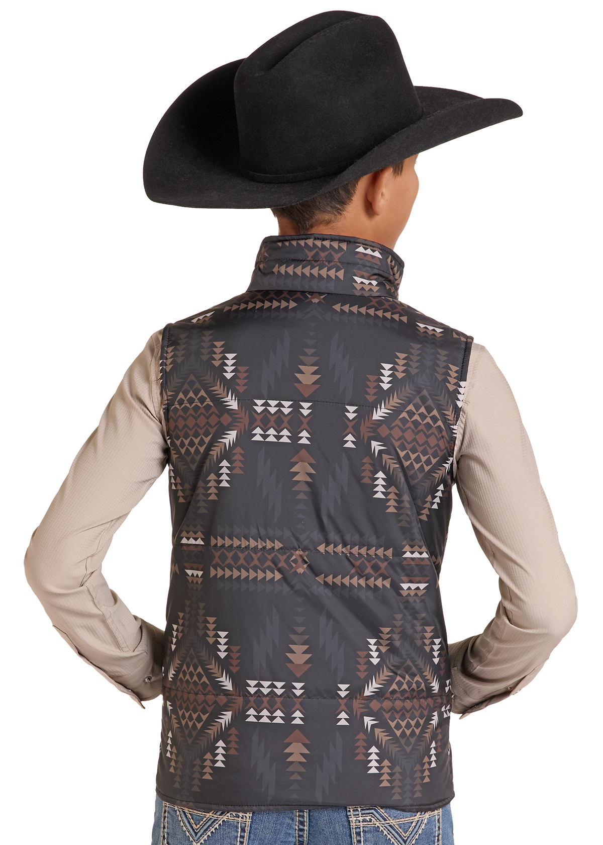 A child shown from the back wearing a black cowboy hat, a beige long-sleeve shirt, and a sleeveless western vest with a dark gray, brown, and white geometric pattern.