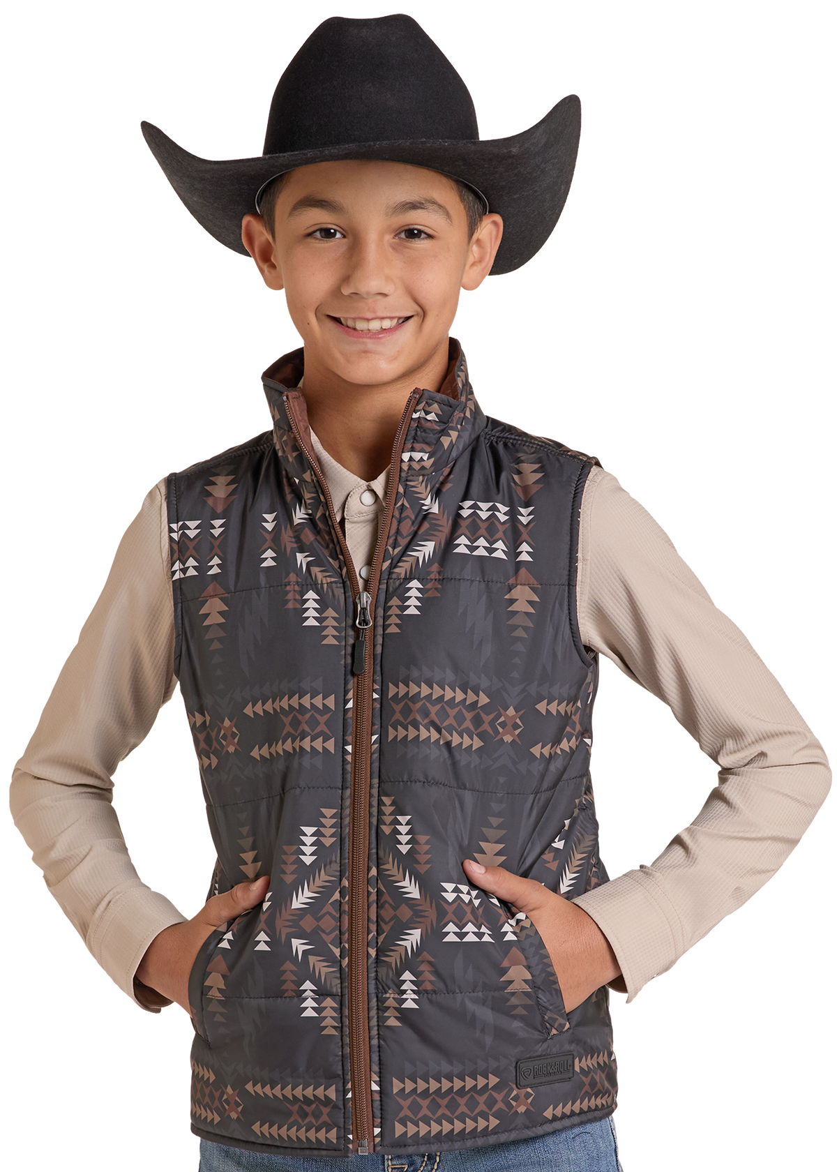 A young boy wearing a black cowboy hat, a beige long-sleeve shirt, and a dark gray zippered vest with a brown and white Southwestern pattern, set against a plain white background.