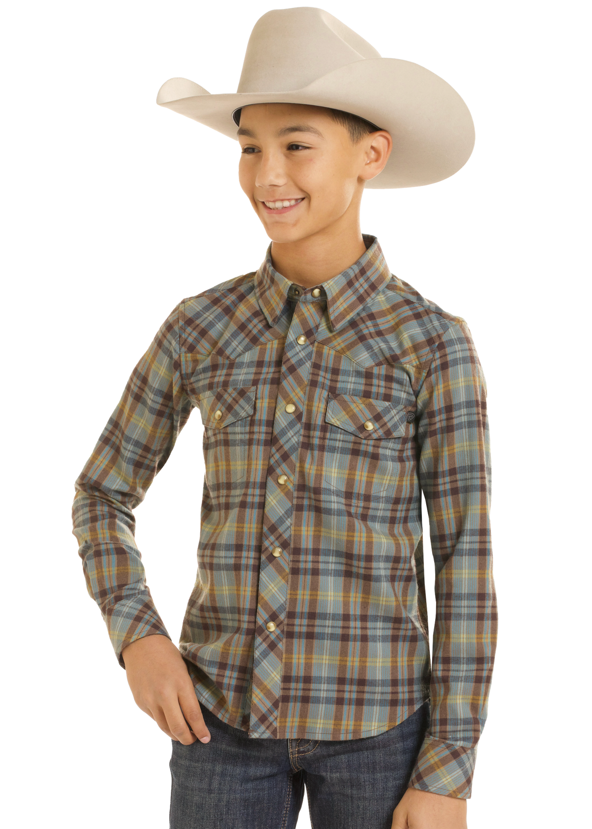 A young boy wearing a long-sleeve western plaid shirt in brown, blue, and beige tones, paired with a cream cowboy hat and dark blue jeans, set against a plain white background.