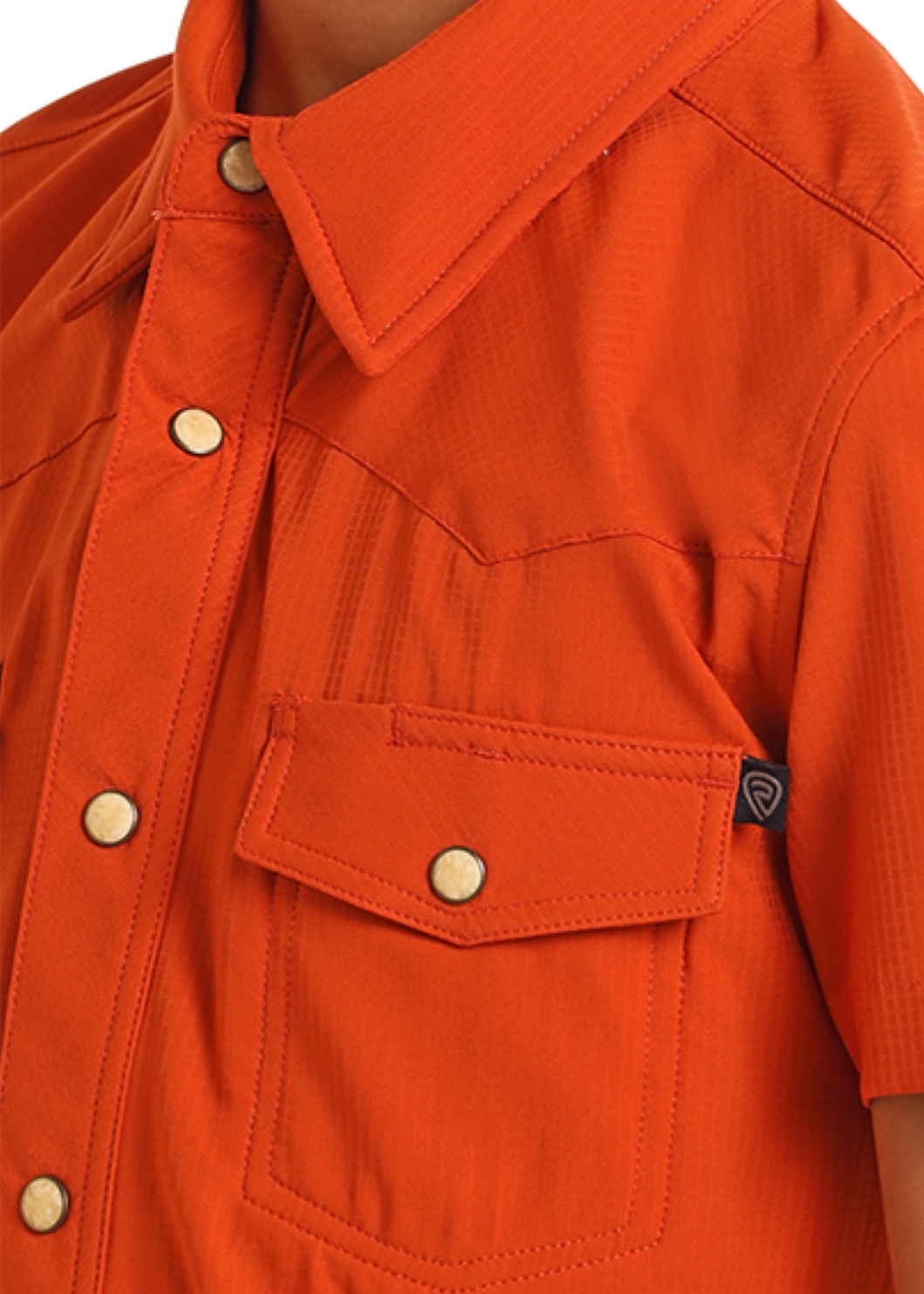 Close-up of an orange shirt with short sleeves and snap details on a white background