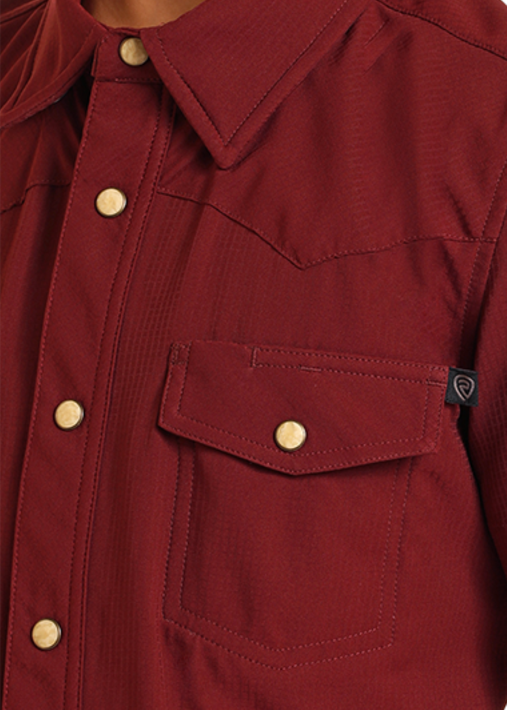 Close-up of a maroon shirt with short sleeves and snap details on a white background