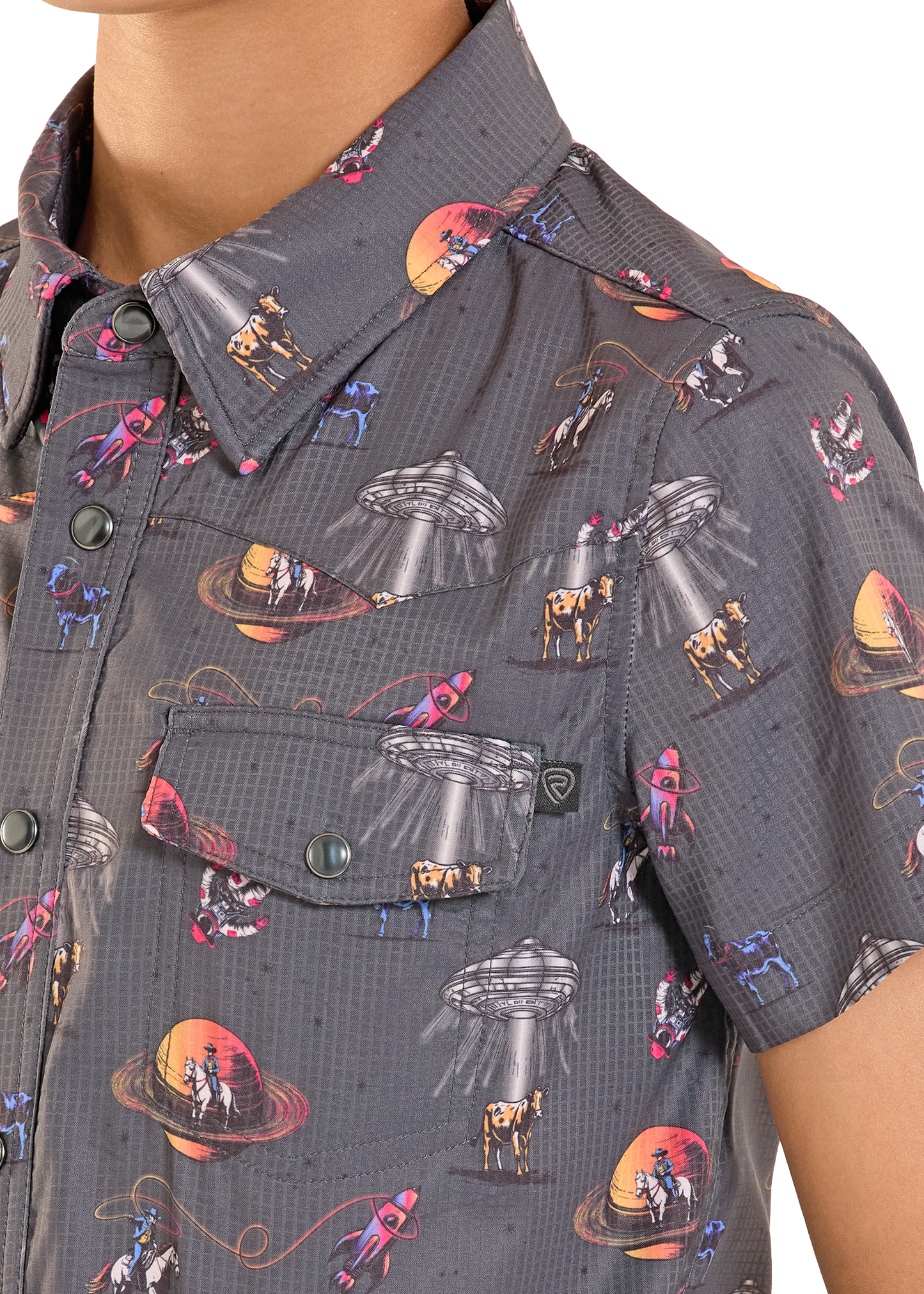Close-up of a shirt with alien and UFO pattern on a dark background