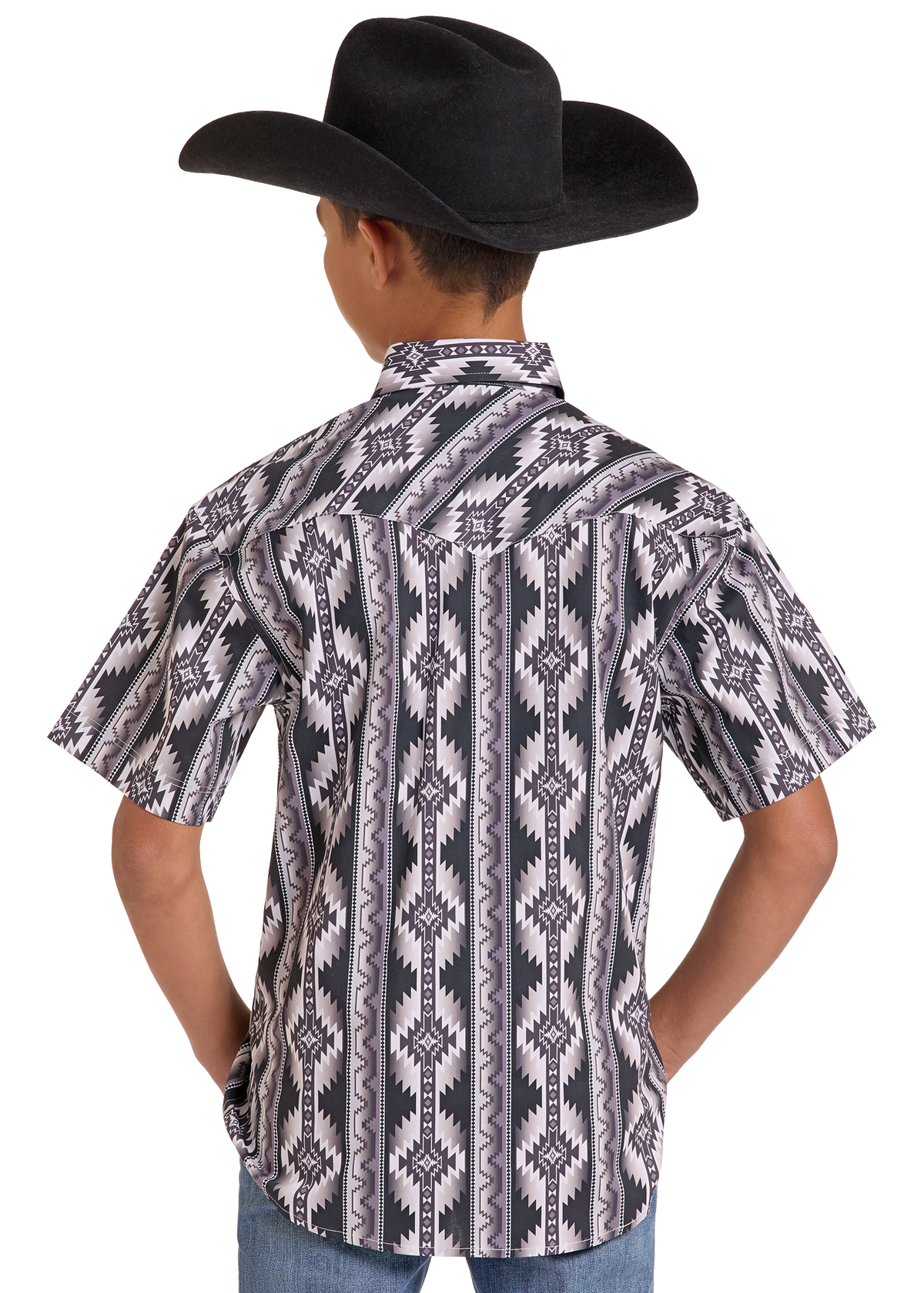 A child shown from the back wearing a black cowboy hat and a short-sleeve western-style button-up shirt with a gray, black, and white geometric pattern, paired with blue jeans against a plain white background.