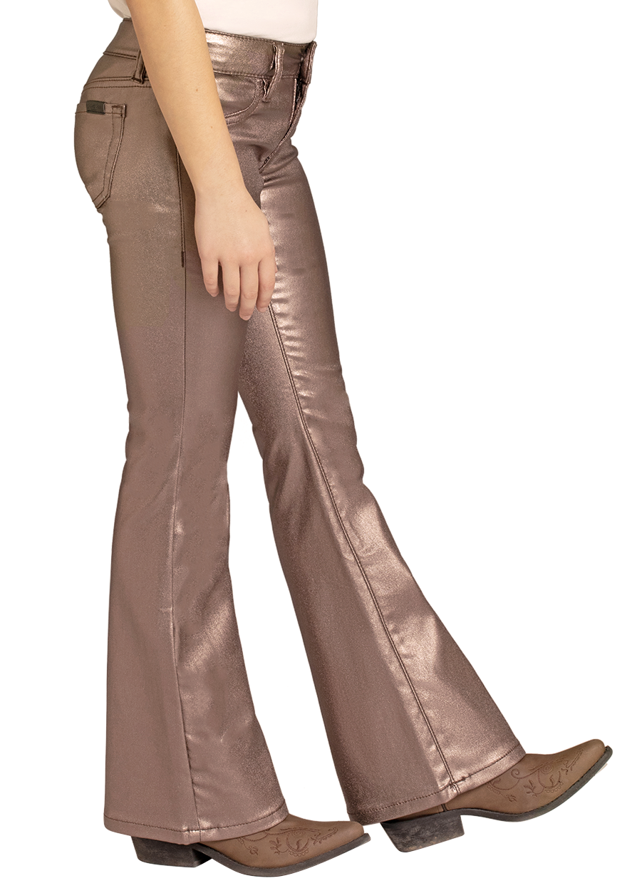 Woman wearing a beige cowboy hat, white shirt, and brown metallic flared pants on a white background