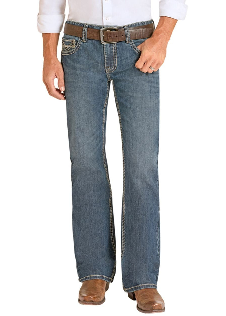 Man wearing a white shirt, blue jeans, and cowboy boots on a white background