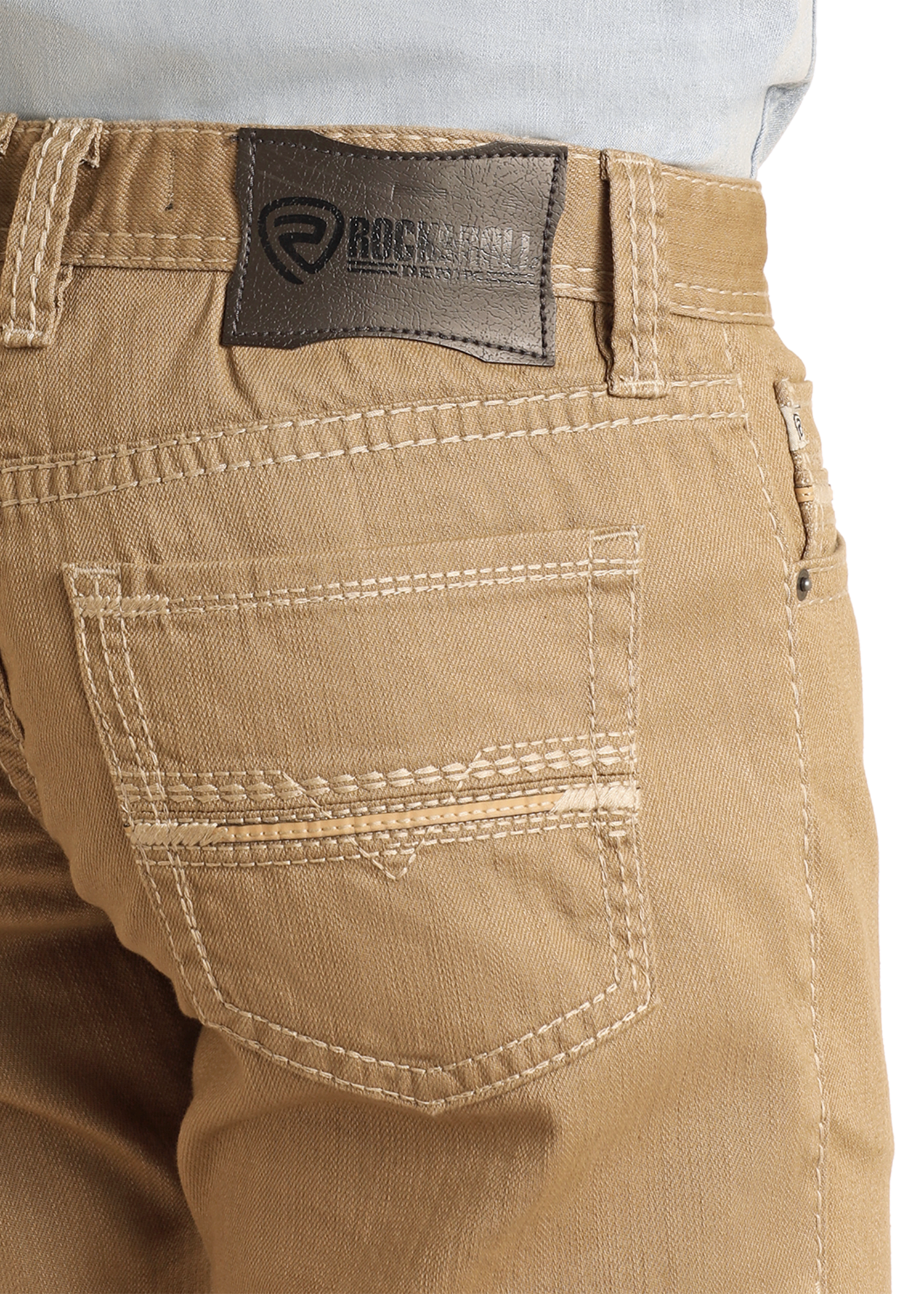 Close-up of beige pants with a brand label on a white background