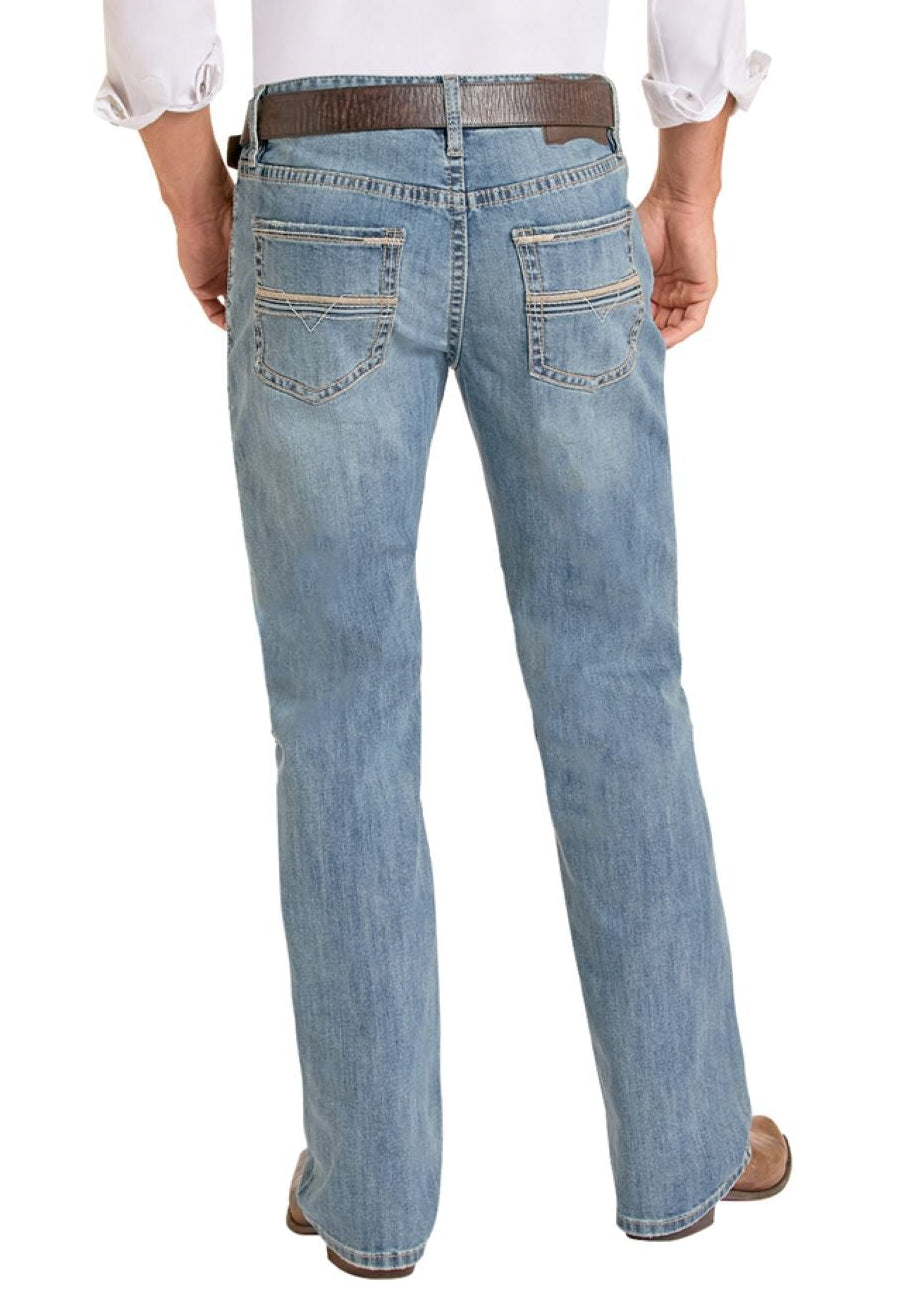 Man wearing a white shirt, light blue jeans, and cowboy boots on a white background