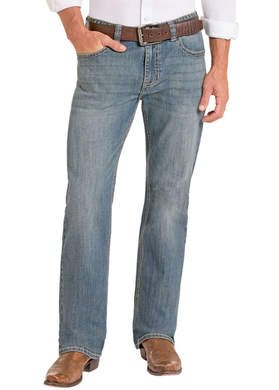 Man wearing a white shirt, blue jeans, and cowboy boots on a white background