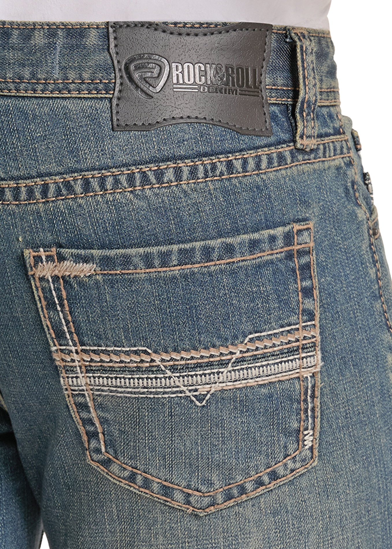 Close-up of the back waistband and pocket area of blue denim jeans, showing a dark gray Rockroll brand patch and contrast tan stitching.