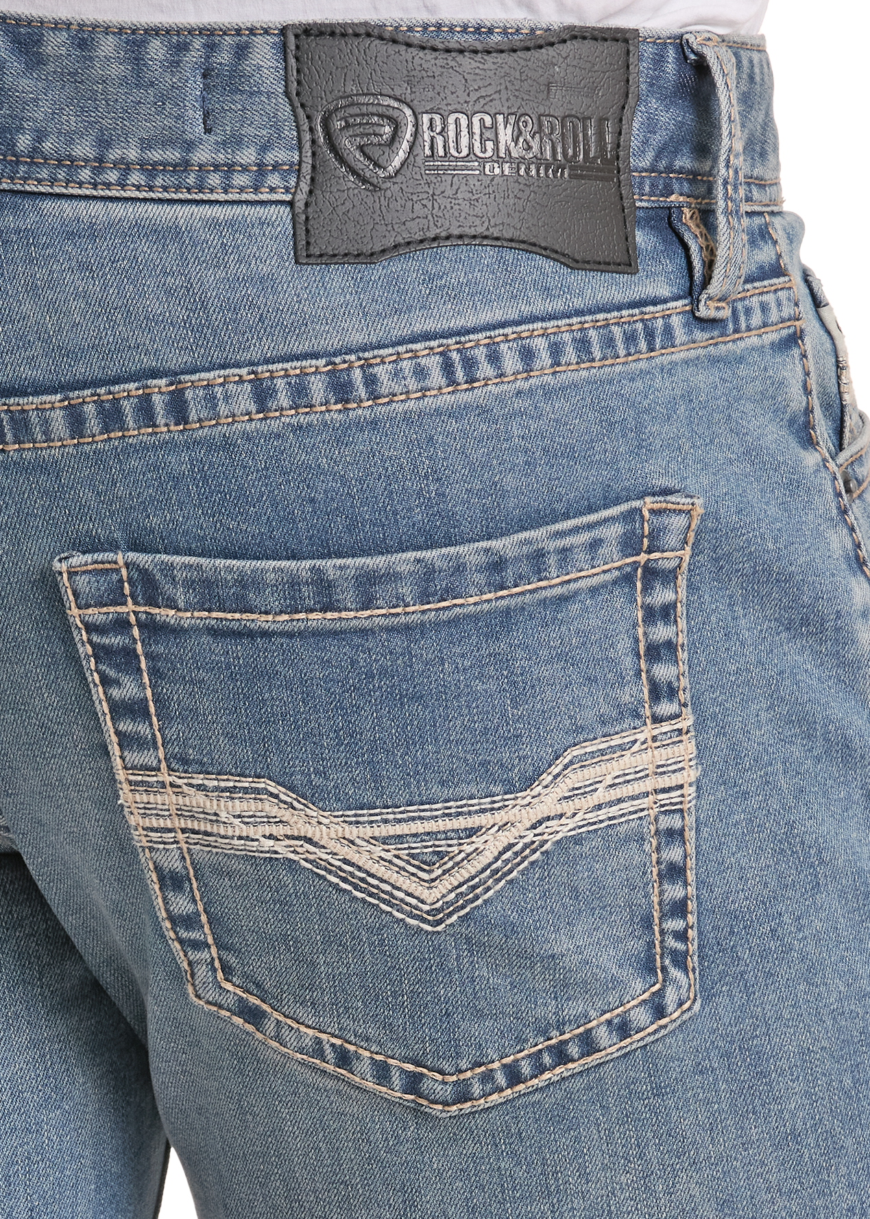 Close-up of the back waistband and pocket area of light blue denim jeans, showing a dark gray RockRoll brand patch and contrast stitching.