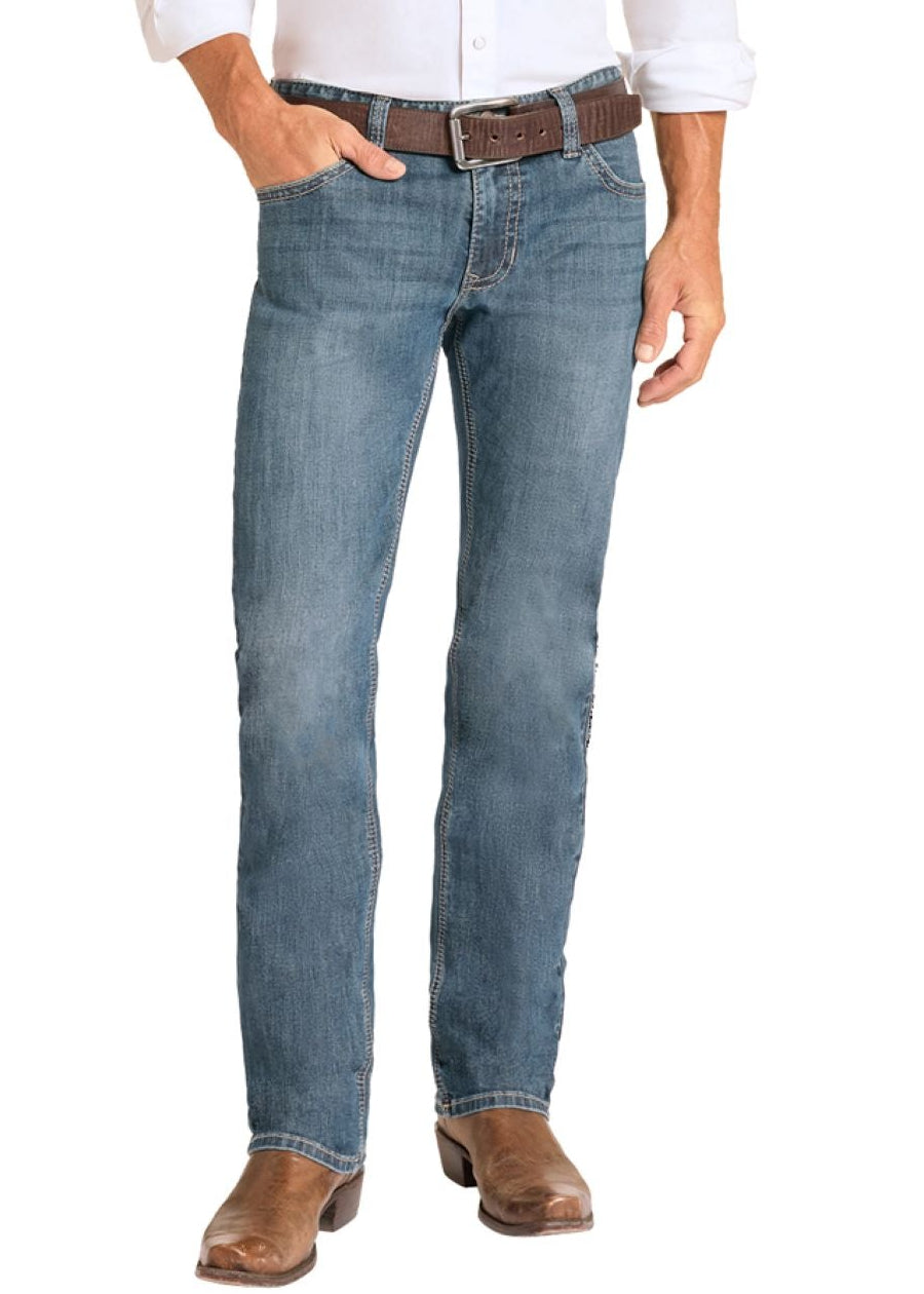Man wearing a white shirt, blue jeans, and cowboy boots on a white background