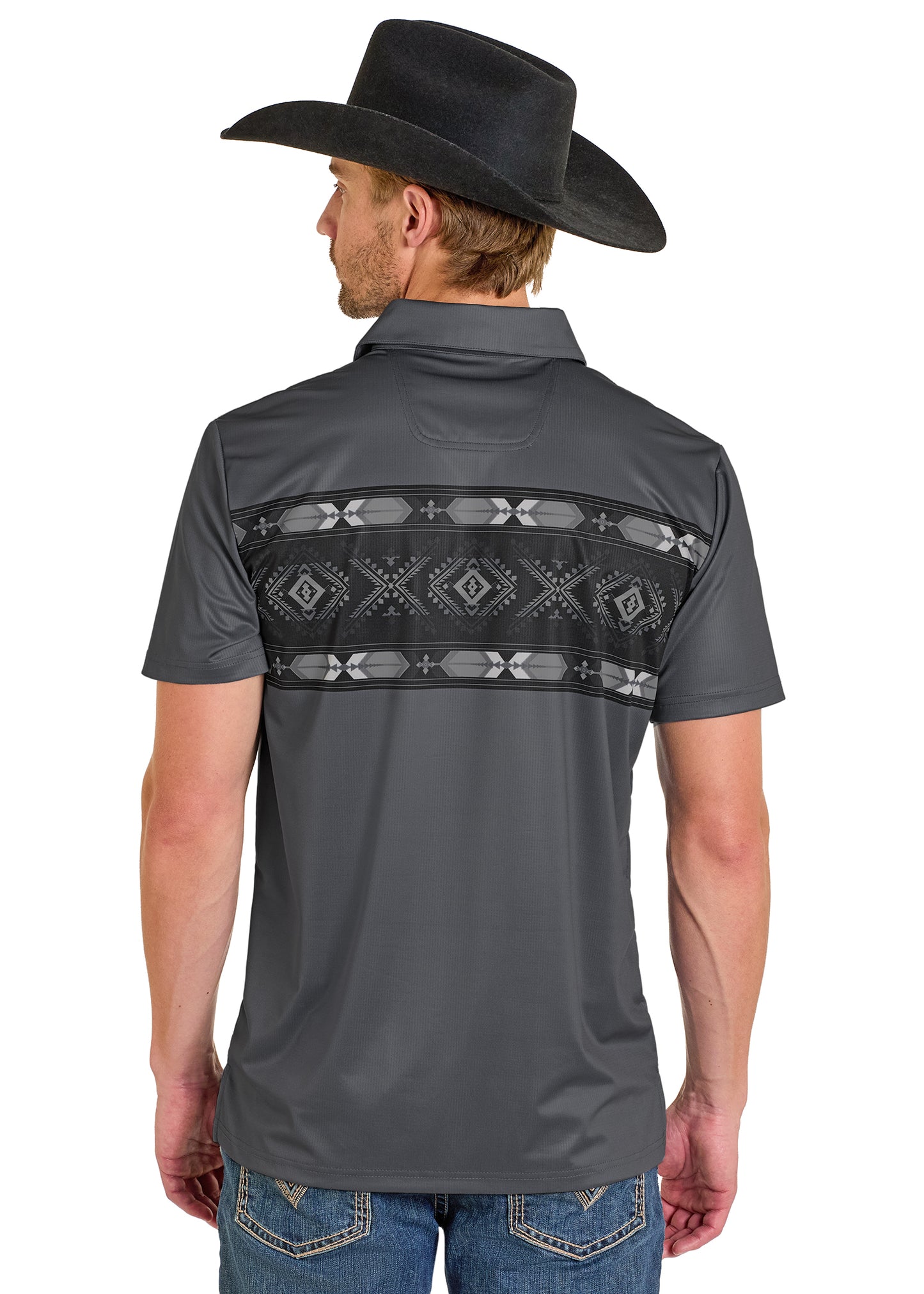 A man wearing a black cowboy hat and blue jeans stands facing away, showcasing the Rock & Roll Denim Grey Diamond Aztec Border Polo with a geometric back pattern.