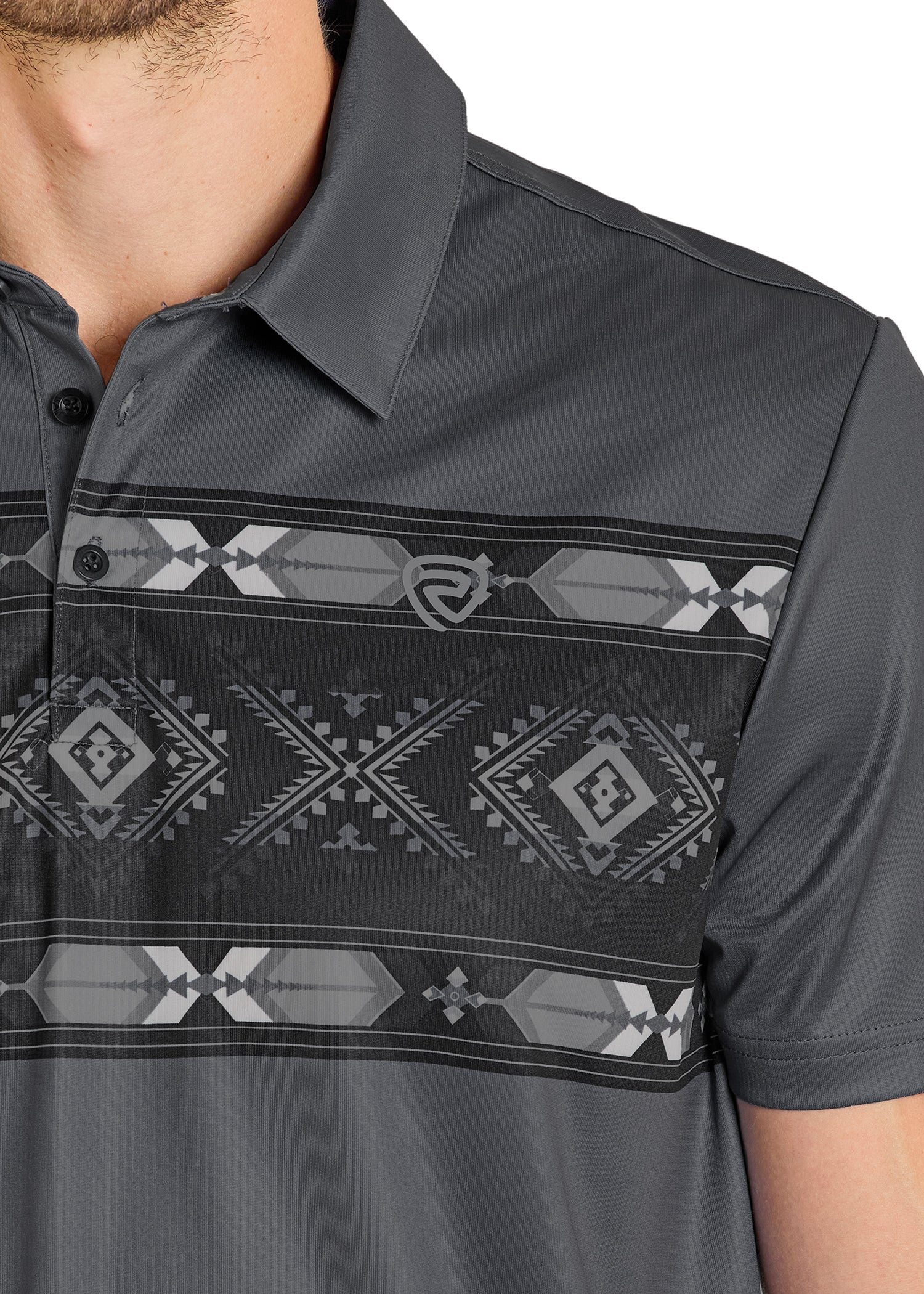 A close-up shows a person in the Rock & Roll Denim Grey Diamond Aztec Border Polo, a regular fit casual top with a black and gray geometric pattern across the chest. Only the lower half of their face, neck, and upper torso are visible.