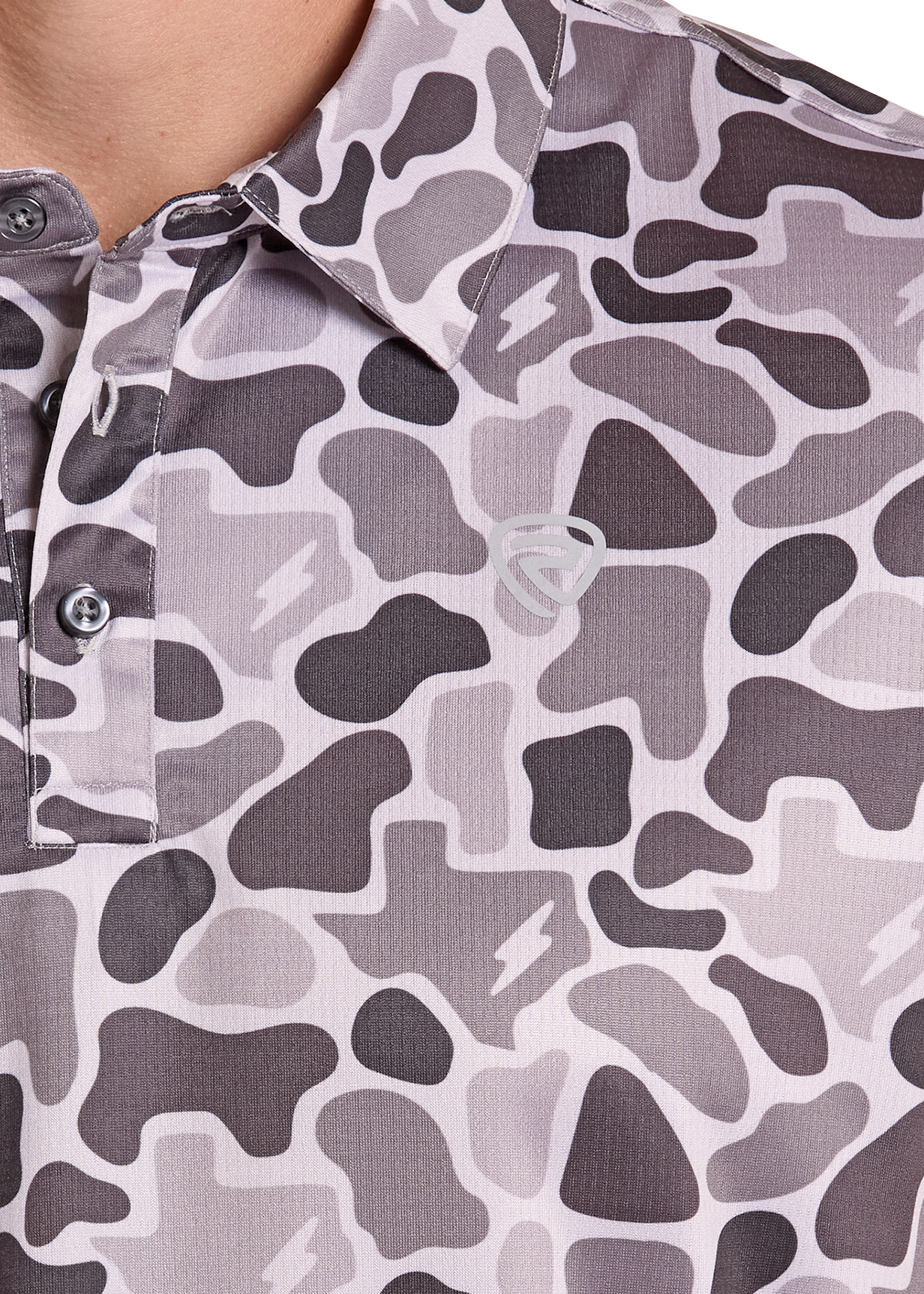 Close-up of a camouflage-patterned shirt with a brand logo on a white background