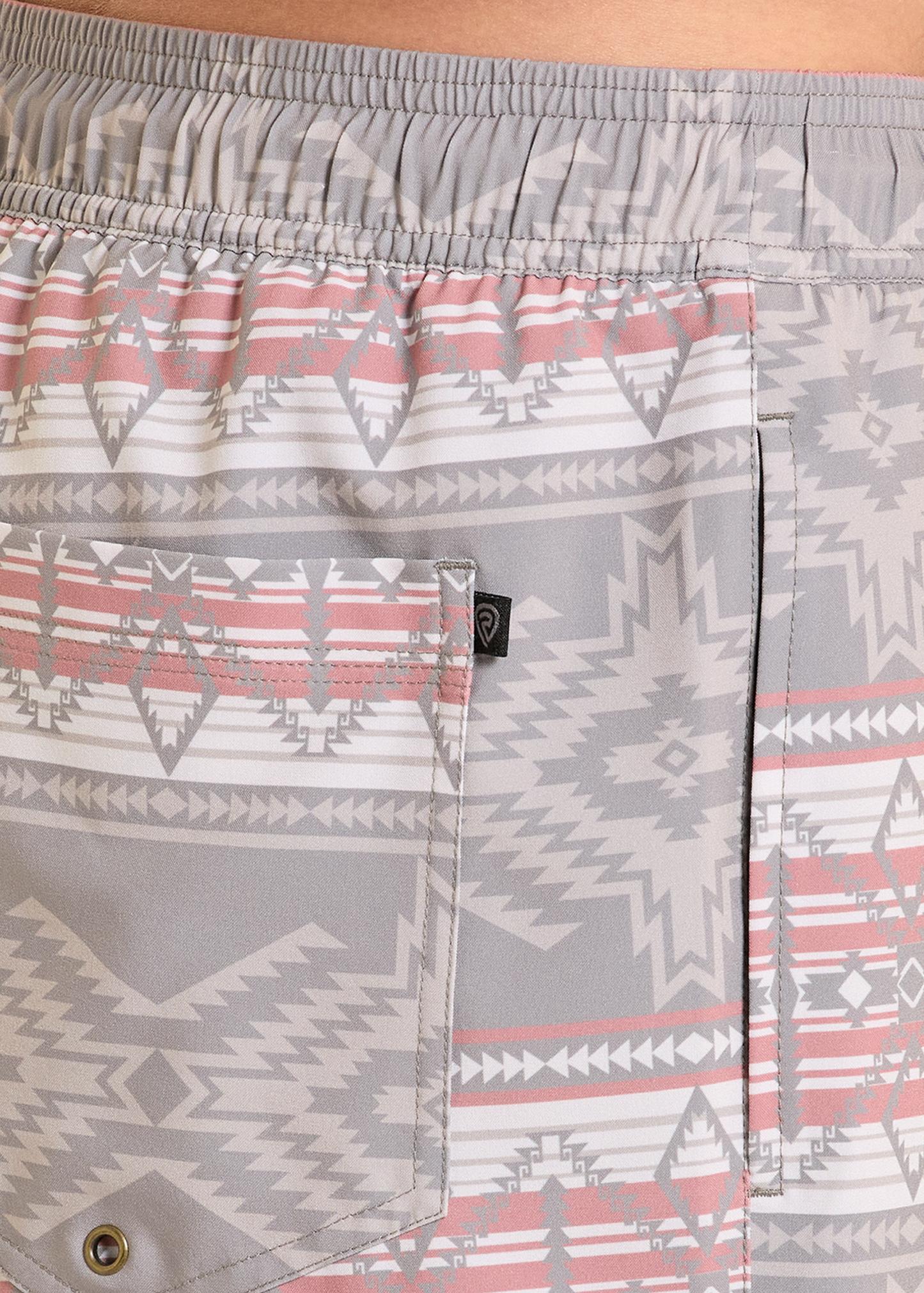 Close-up of patterned shorts with a visible brand logo on the pocket.