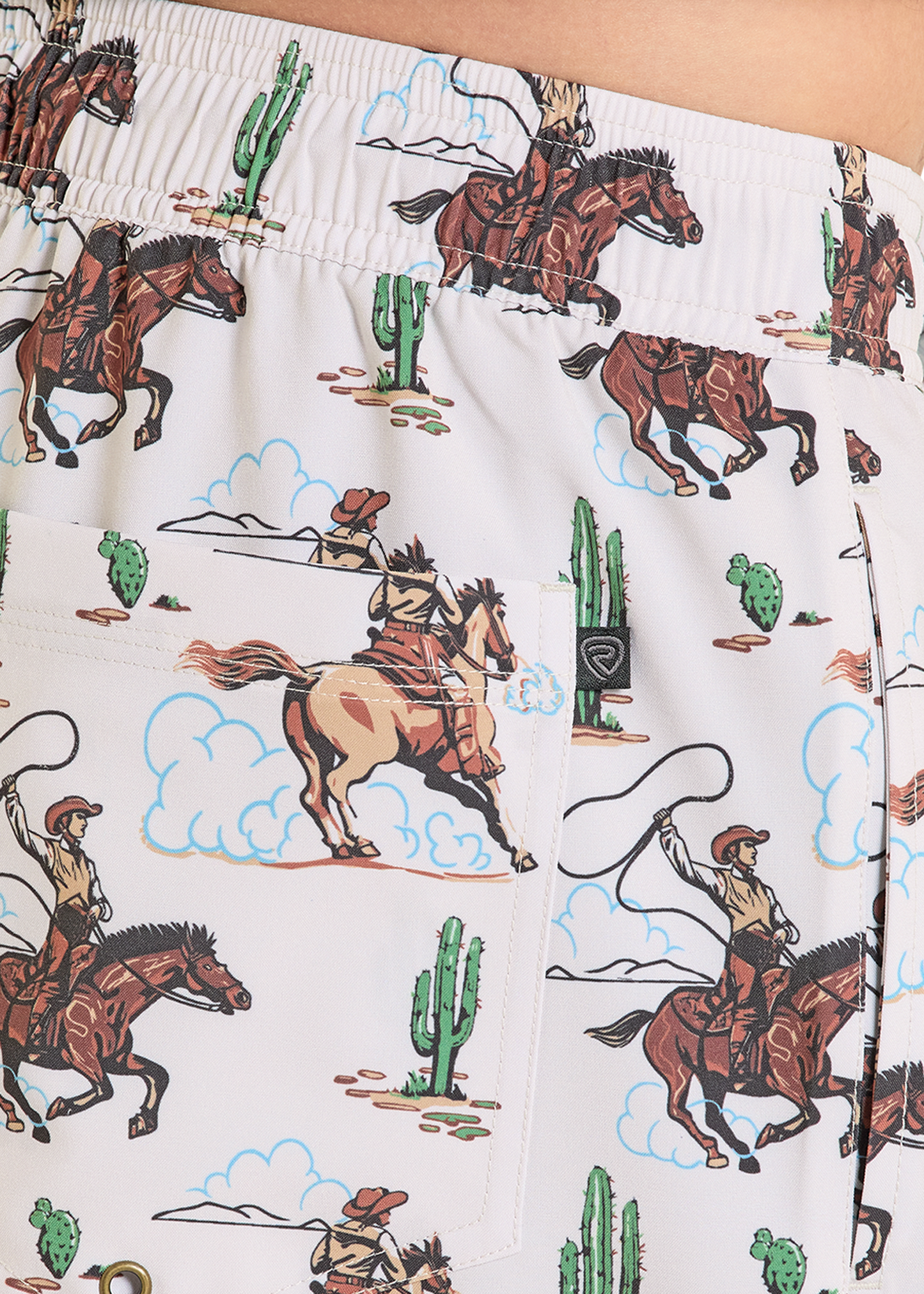 Swim trunks with cowboy and horse pattern on a white background