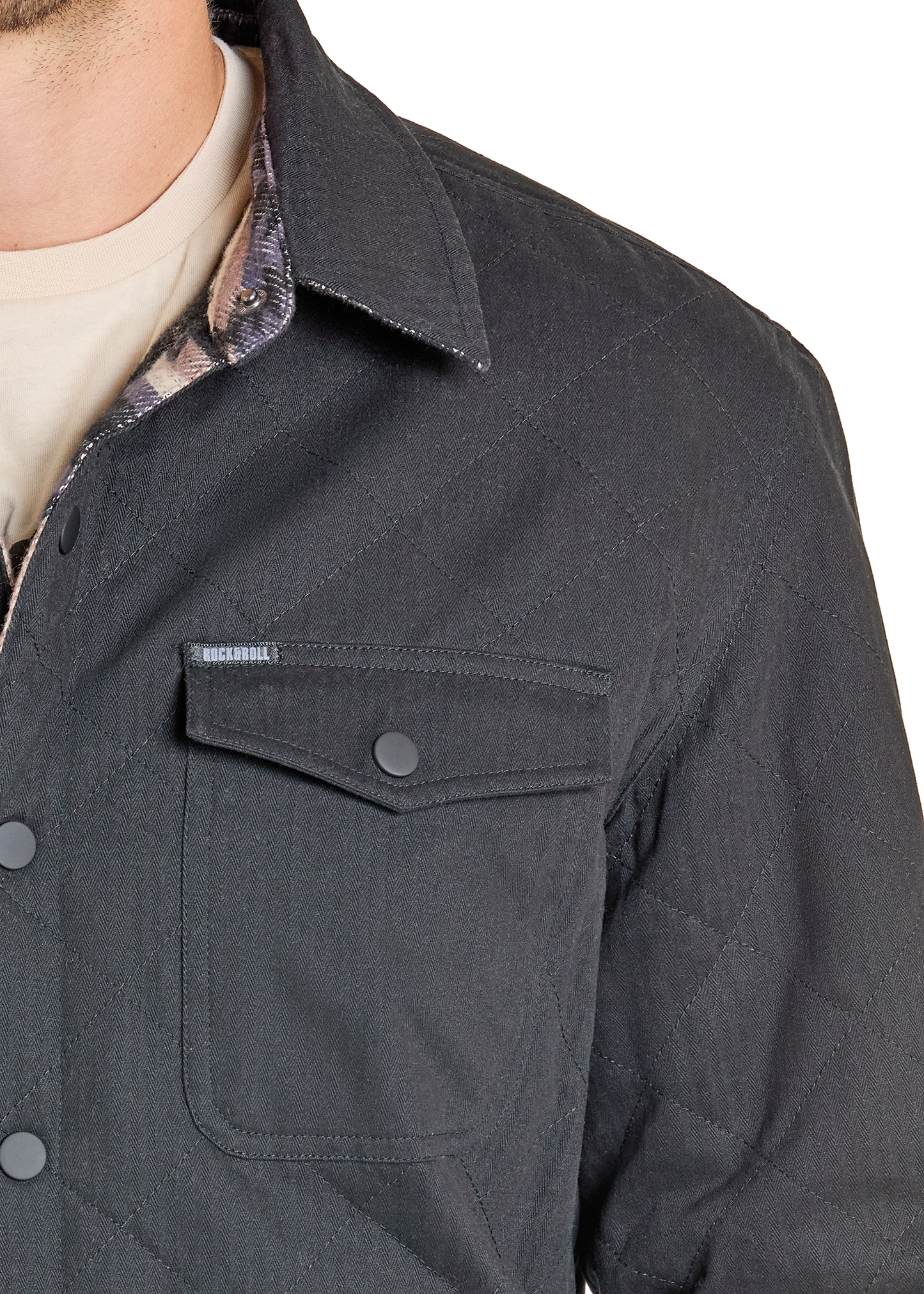Close-up of a dark gray jacket with a pocket and collar, featuring a brand label.