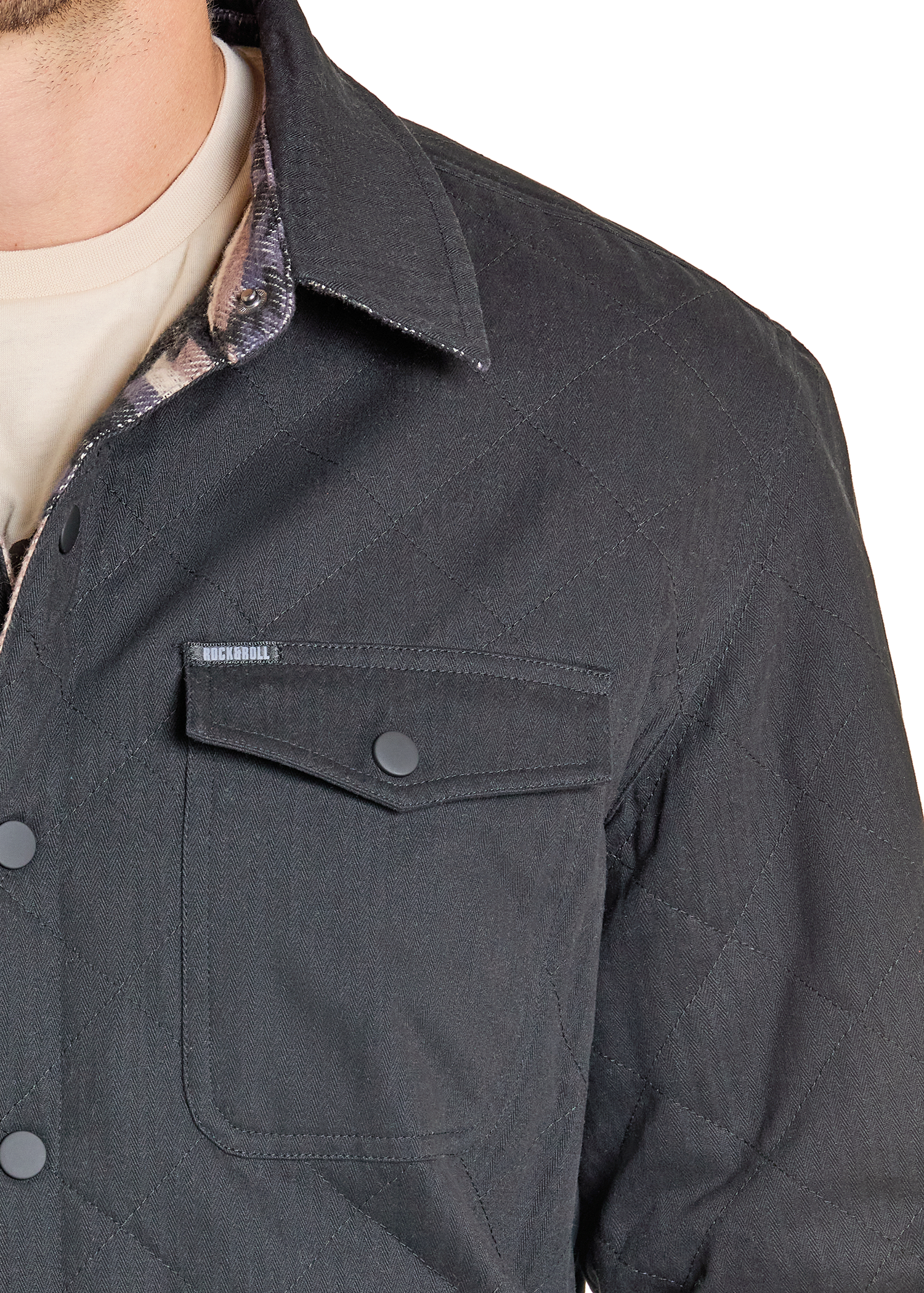 Close-up of a dark gray jacket with a pocket and collar, featuring a brand label.