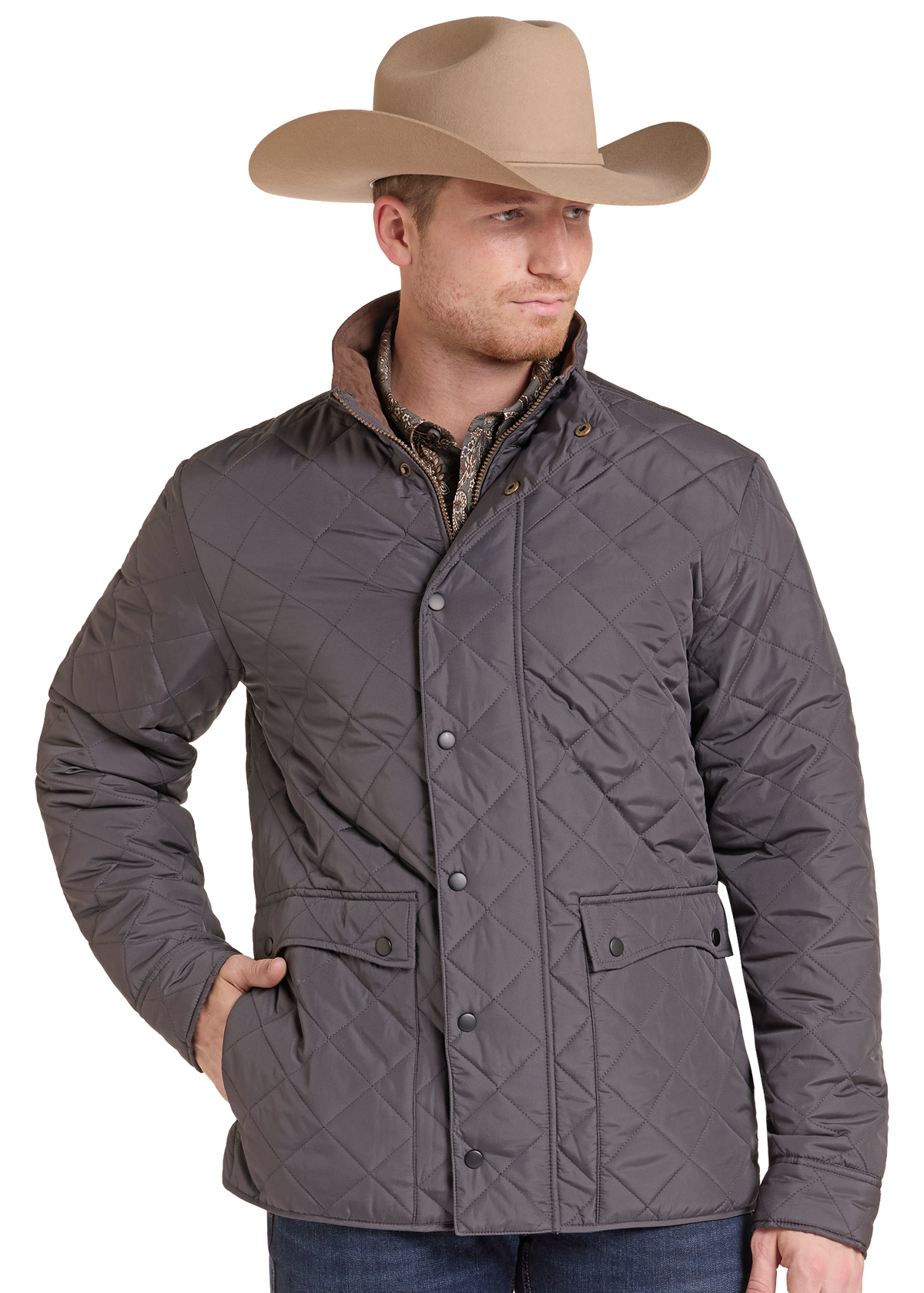 A man wearing a tan cowboy hat and a dark gray diamond-quilted jacket over a patterned shirt, photographed against a plain white background.