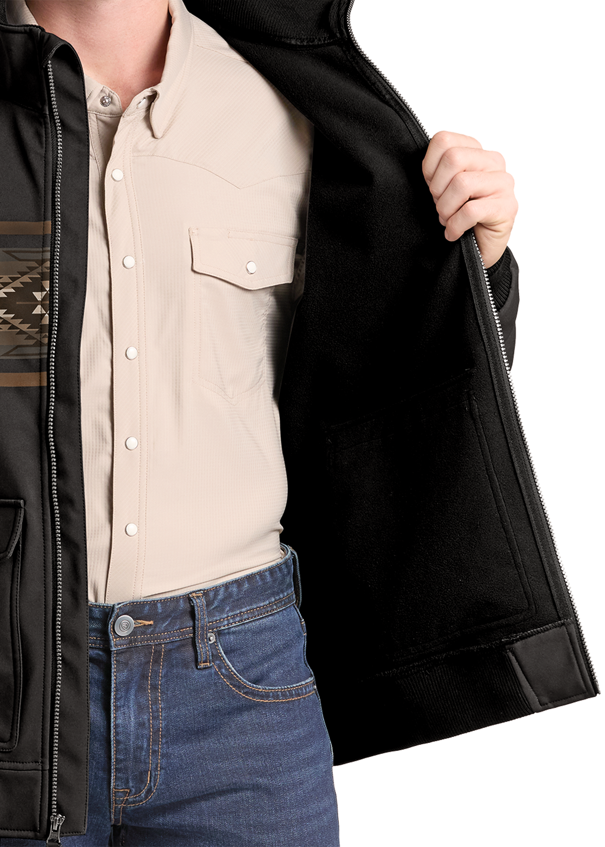 A close-up of a person wearing a black zip-front jacket over a light beige western-style button-up shirt and blue jeans, with the jacket being opened to show the black interior.