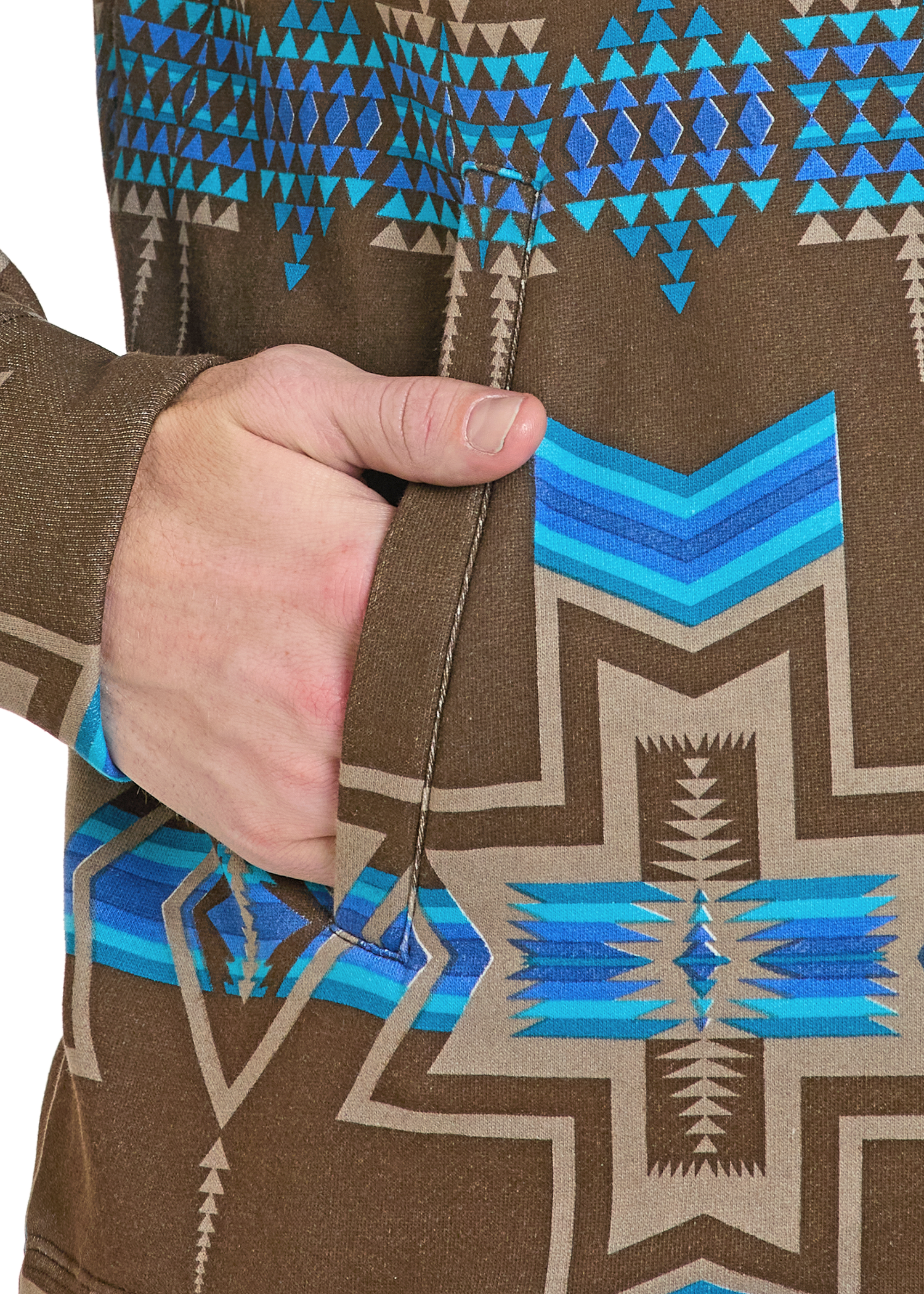 Close-up of a brown jacket with blue and beige geometric pattern, held by a hand.