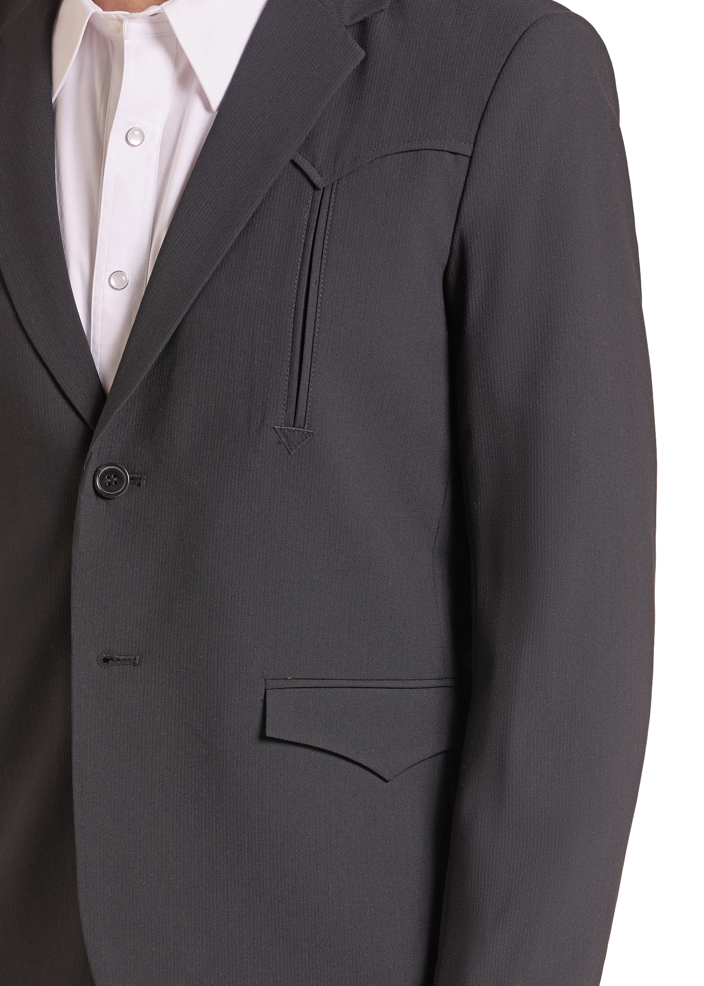 Close-up of a dark charcoal gray suit jacket worn over a white collared dress shirt, showing the lapel, button closure, chest pocket, and front flap pocket.