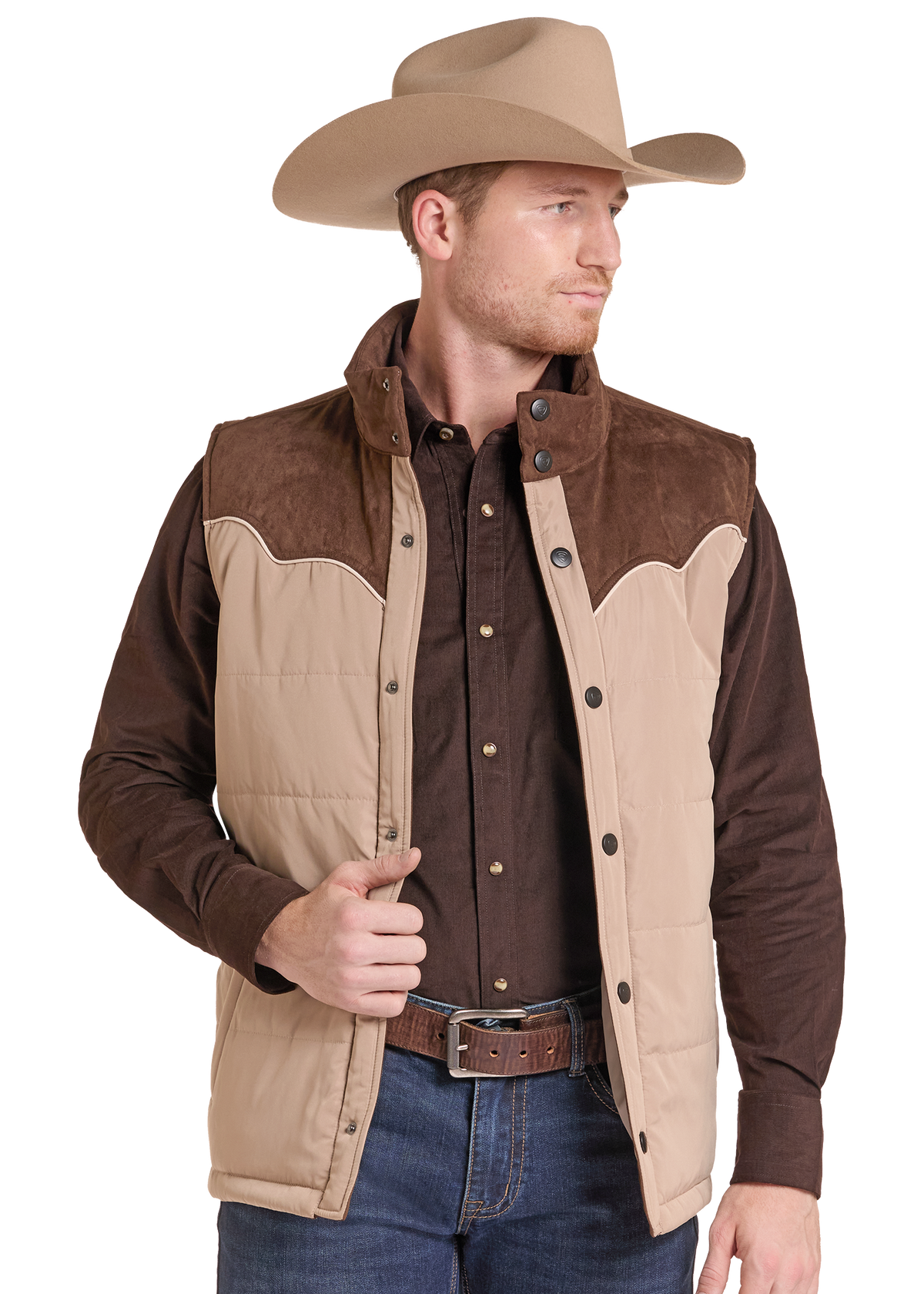 A man wearing a tan and brown western-style quilted vest over a dark brown button-up shirt, blue jeans, and a tan cowboy hat, shown against a plain white background.