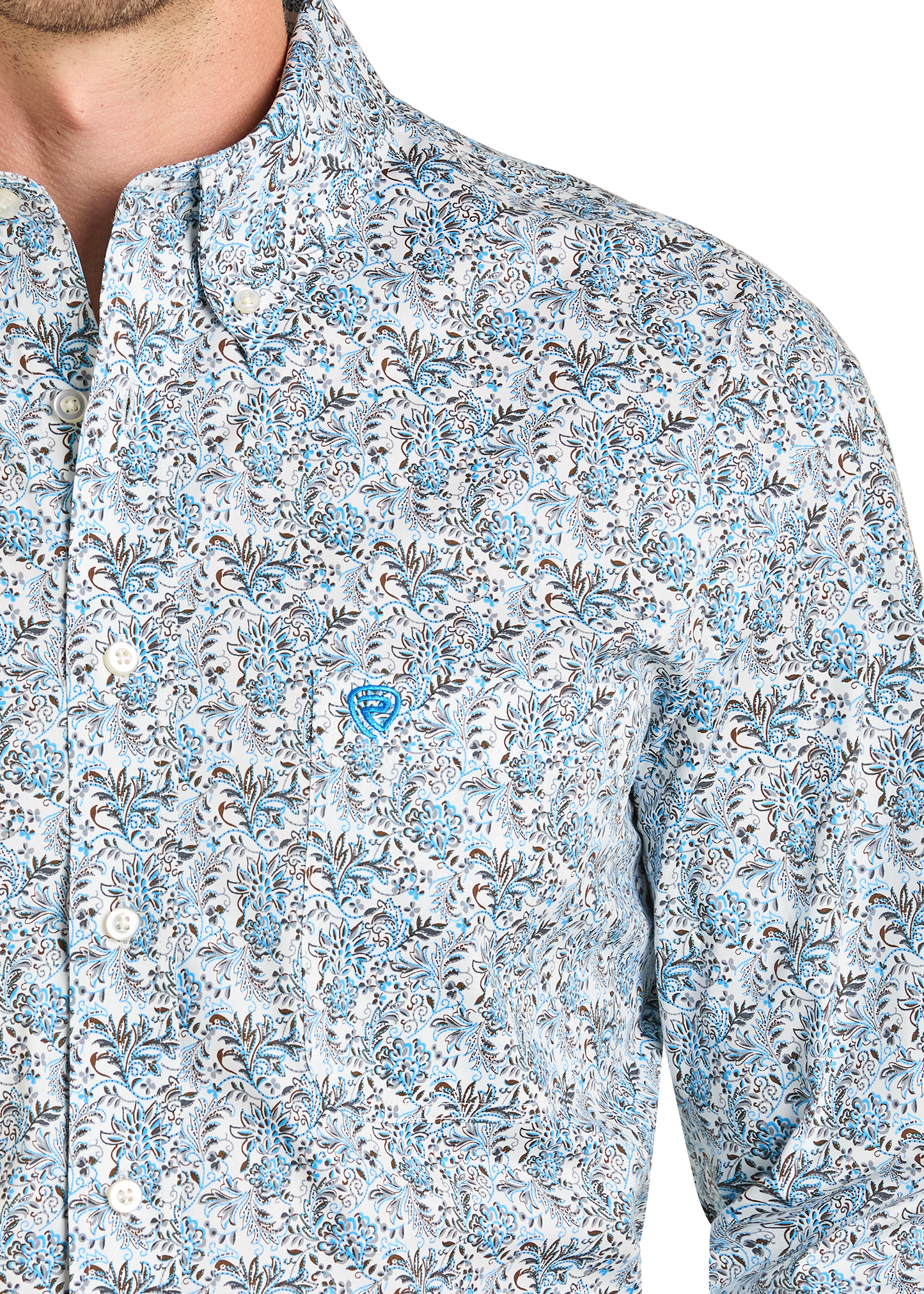Close up of a man wearing a patterned shirt.