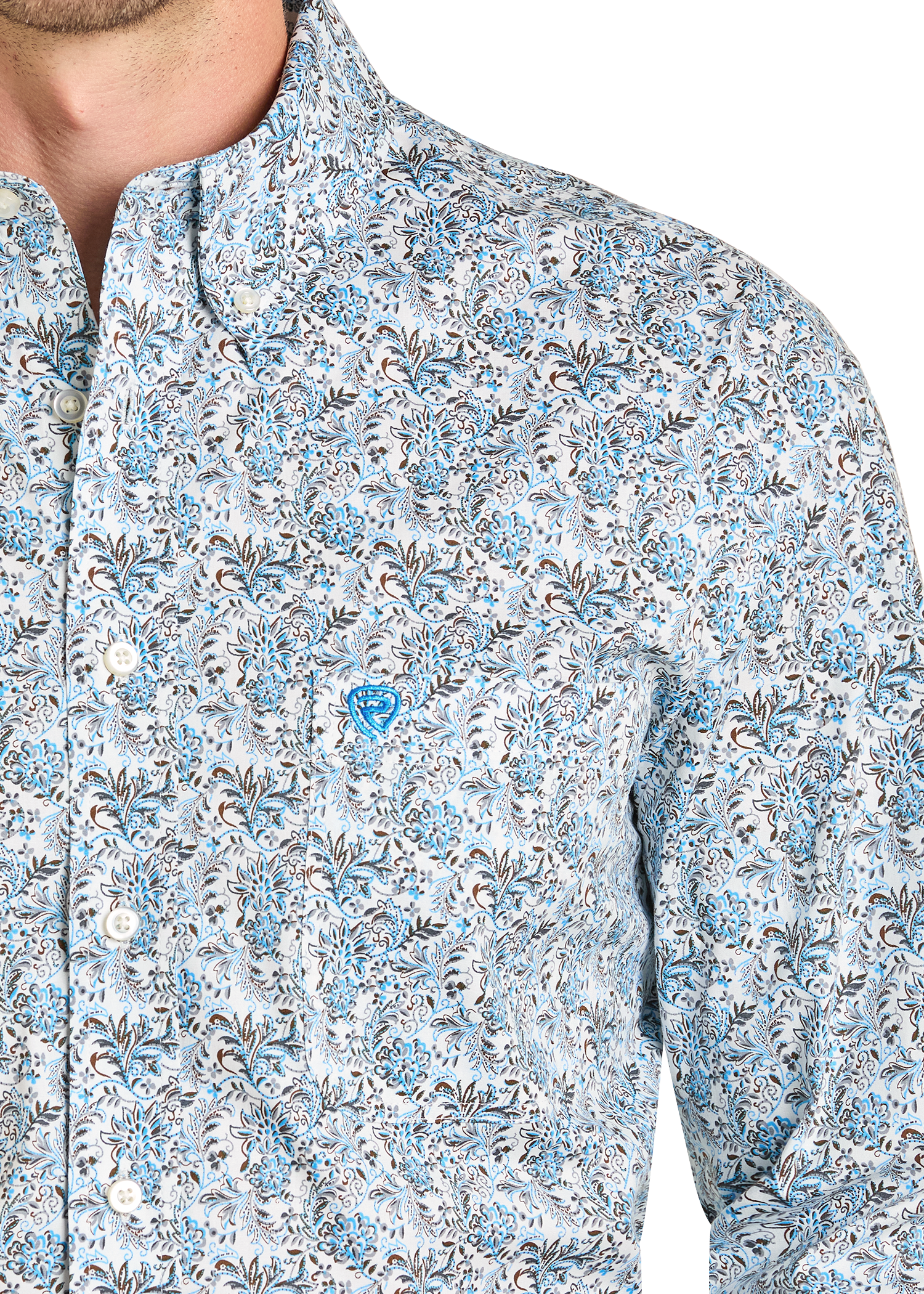 Close up of a man wearing a patterned shirt.