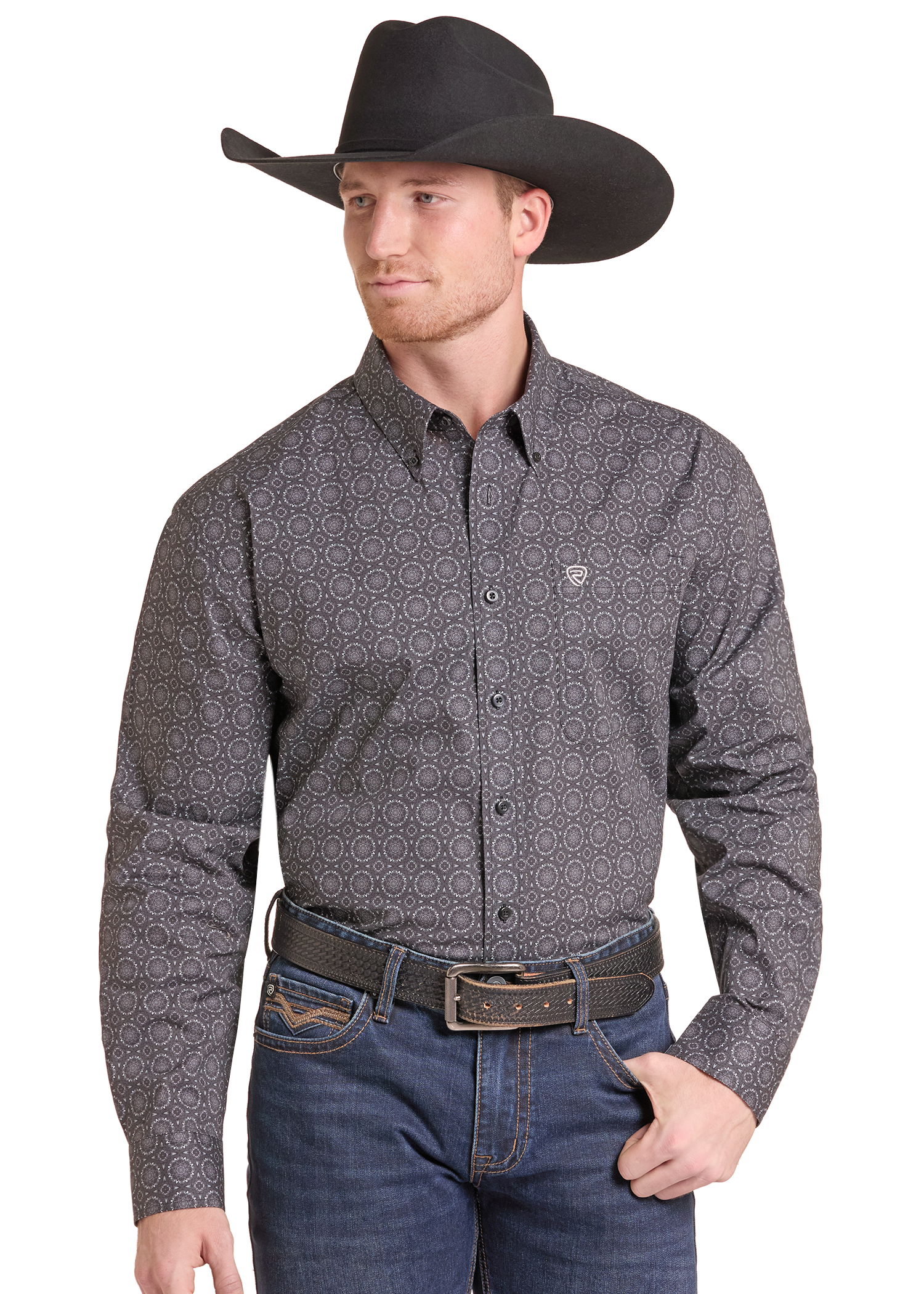 A man wearing a long-sleeve western-style button-down shirt with a small-scale geometric pattern in dark gray and black, paired with a black cowboy hat, brown belt, and blue jeans against a plain white background.