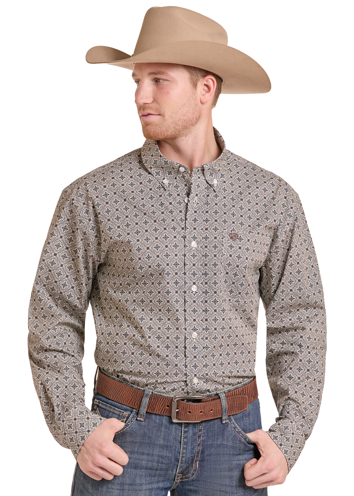 A man wearing a tan cowboy hat, a long-sleeve button-down western shirt with a small geometric pattern in beige and brown, blue jeans, and a brown belt, photographed against a plain white background.