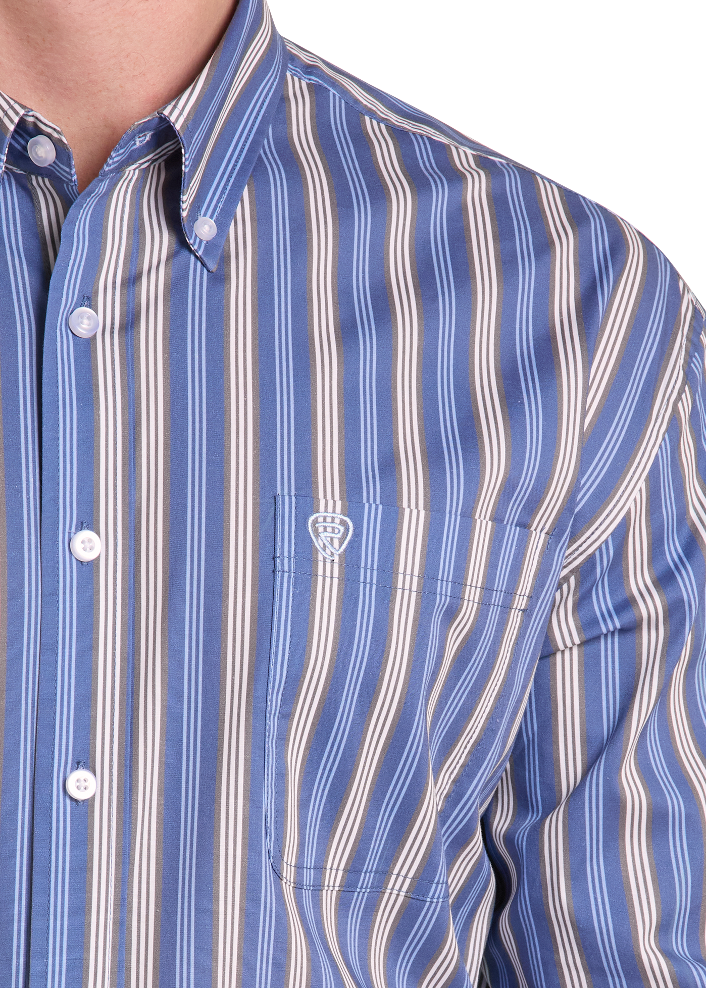 Close-up of a man wearing a blue button-down shirt with vertical cream and white stripes and a small embroidered crest on the chest pocket.