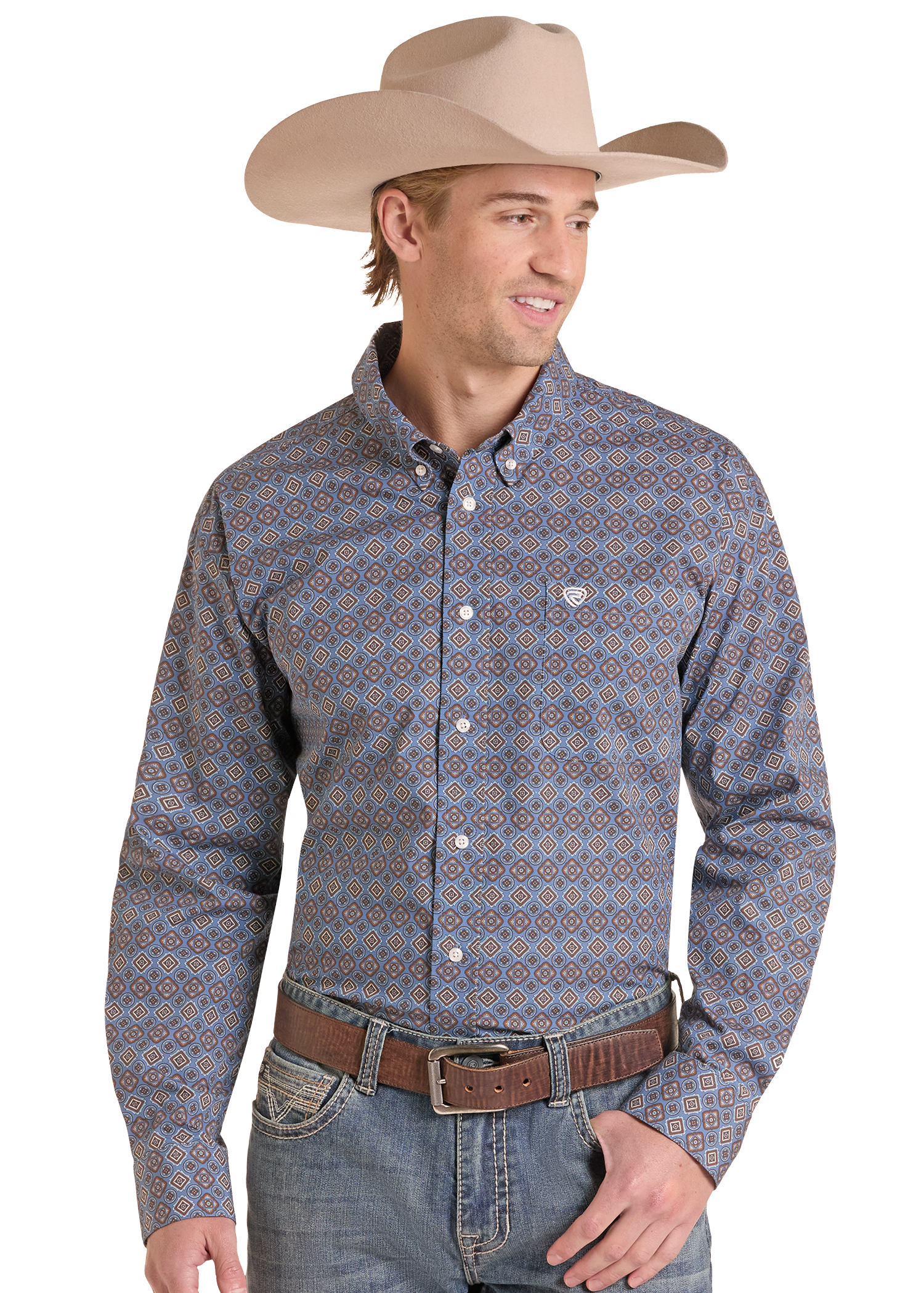 A man wearing a long-sleeve western button-down shirt with a blue, orange, and white geometric pattern, paired with a tan cowboy hat, brown belt, and blue jeans, set against a plain white background.