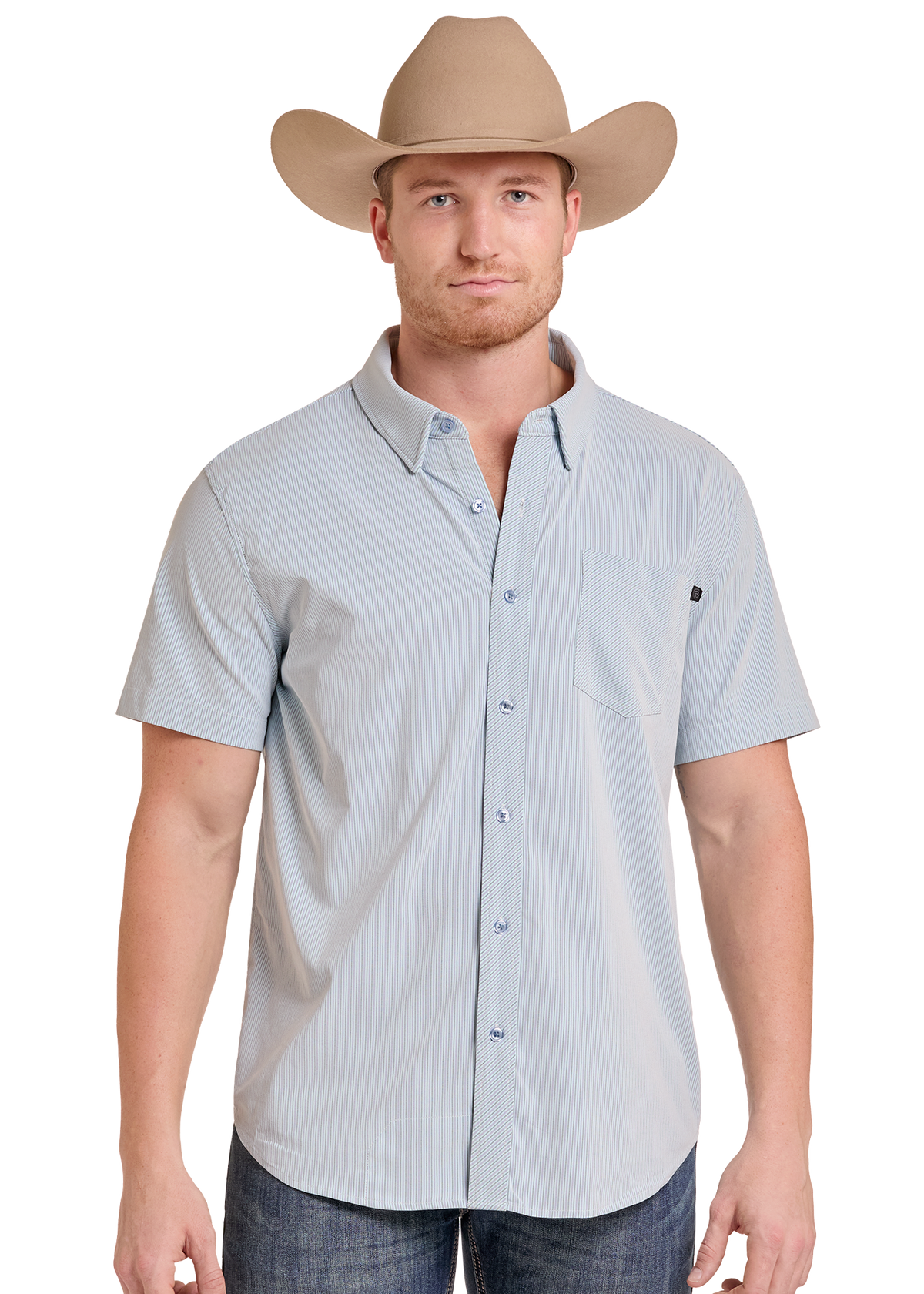 A man wearing a light blue short-sleeve button-down shirt with a chest pocket and a tan cowboy hat, standing against a plain white background.