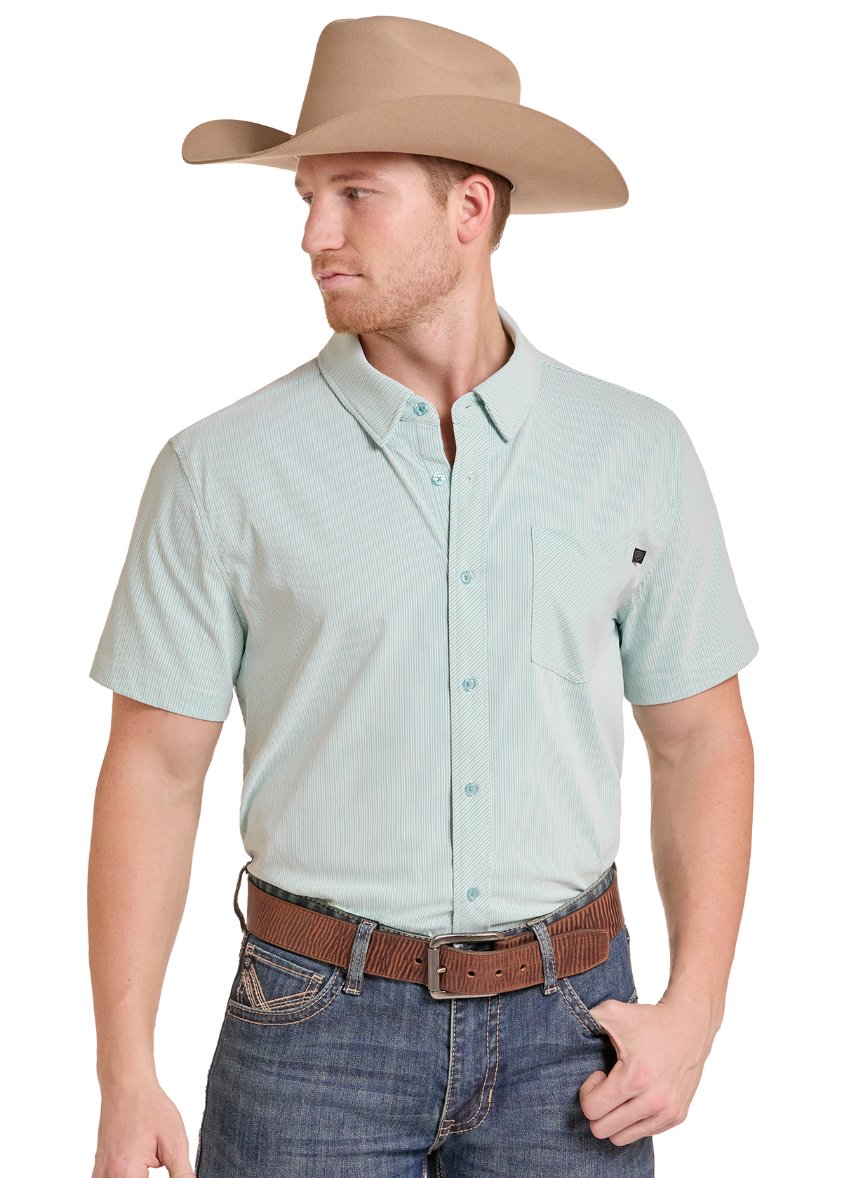 A man wearing a light sage green short-sleeve button-down shirt, a tan cowboy hat, and a brown belt, shown against a plain white background.
