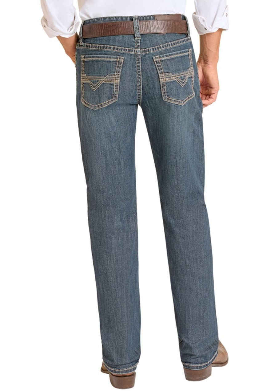 Man wearing a white shirt, blue jeans, and cowboy boots on a white background