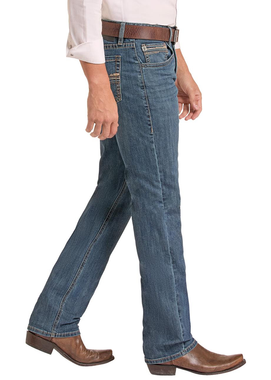 A man wearing a light pink western long-sleeve shirt, blue jeans, a brown belt, brown boots, and a black cowboy hat, shown in profile against a white background.