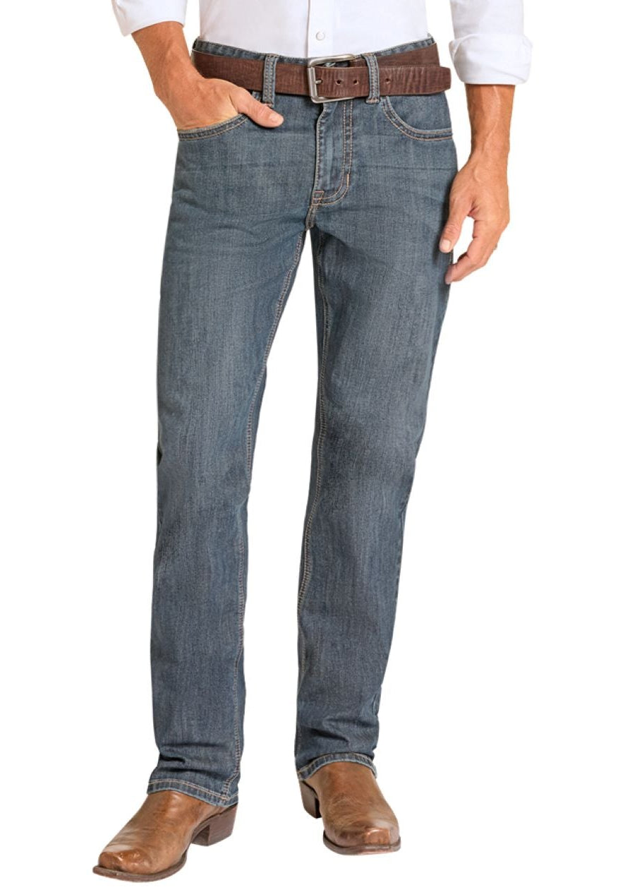 Man wearing a white shirt, blue jeans, and cowboy boots on a white background