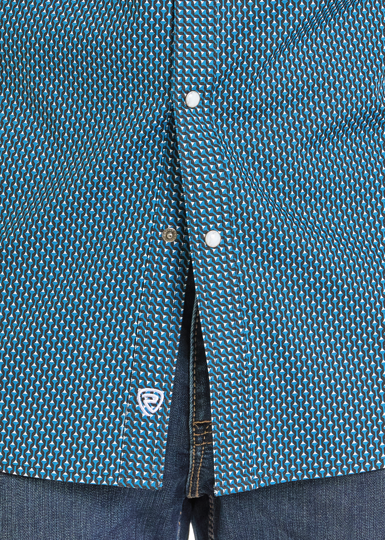 Close up of a geometric pearl snap shirt. 