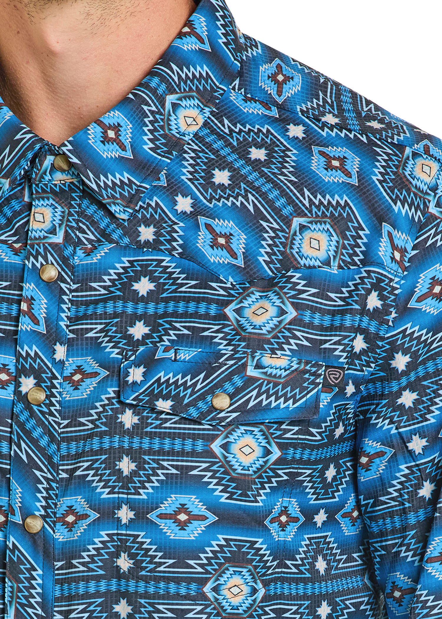 Detail close up of a Western Aztec pearl snap shirt. 