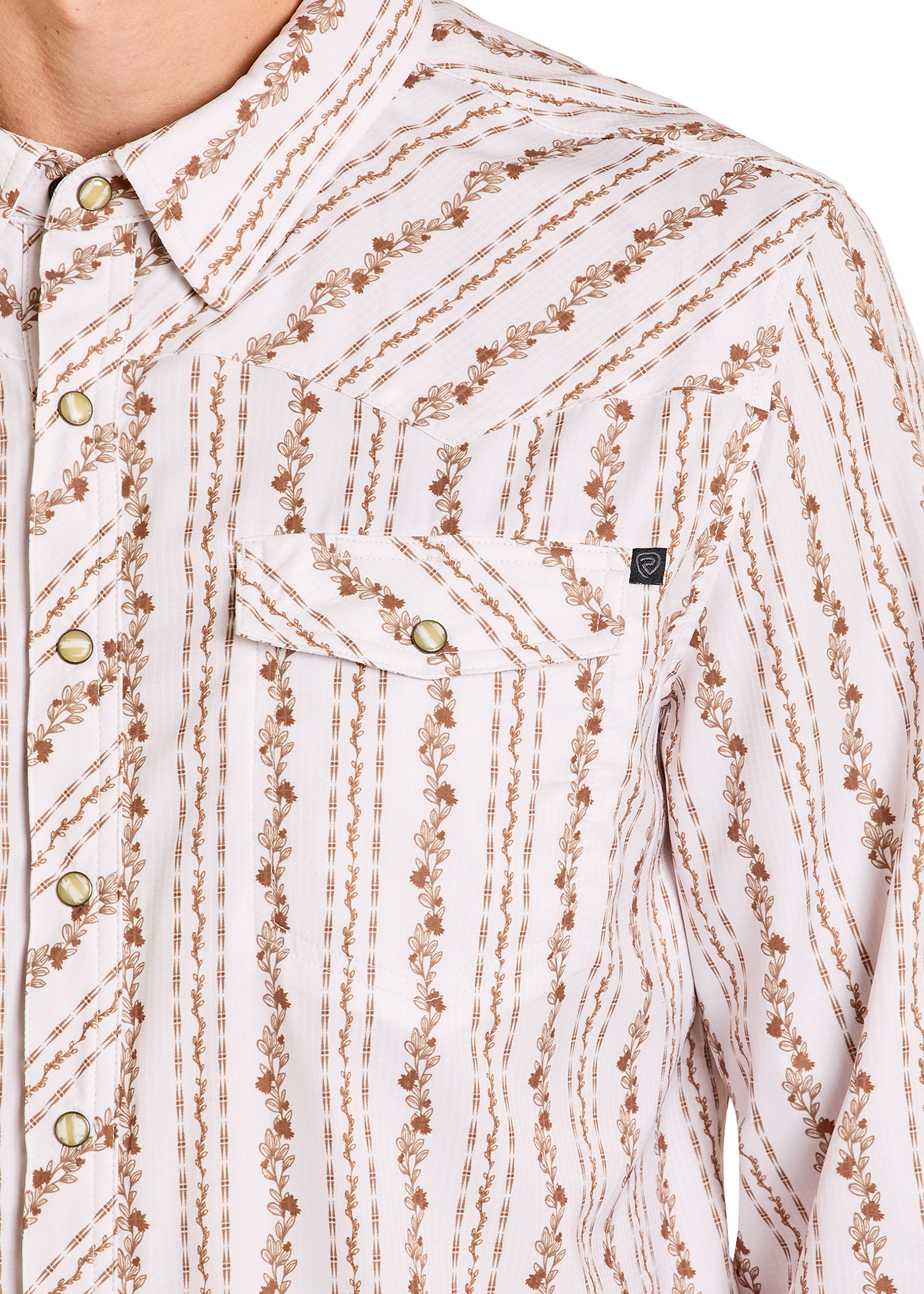 Close-up of a patterned shirt with brown and beige design on a white background