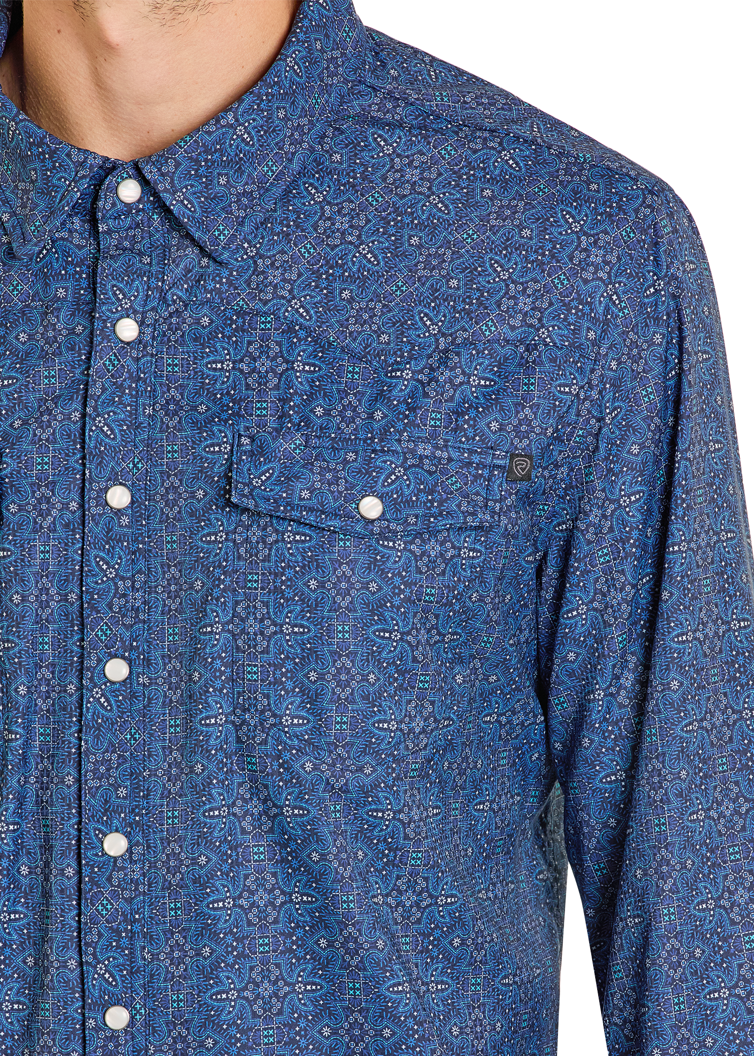 Close-up of a blue patterned shirt with buttons on a white background