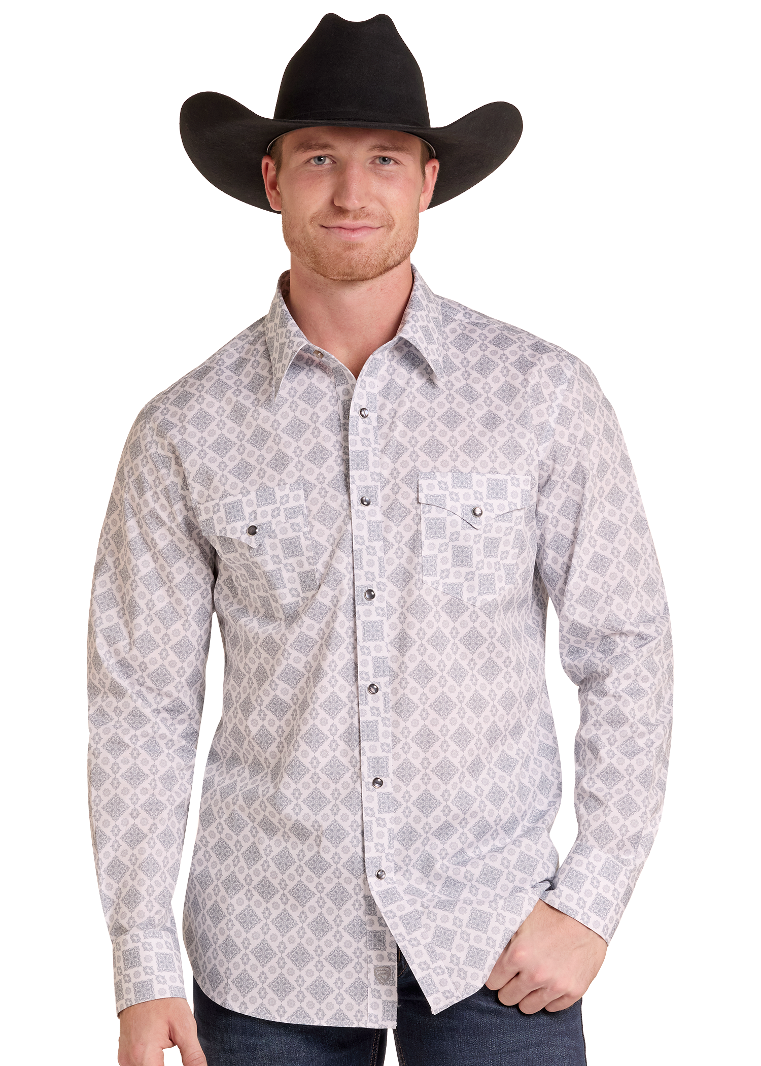 A man wearing a black cowboy hat and a light gray long-sleeve western shirt with a dark gray geometric pattern, paired with dark jeans, against a plain white background.