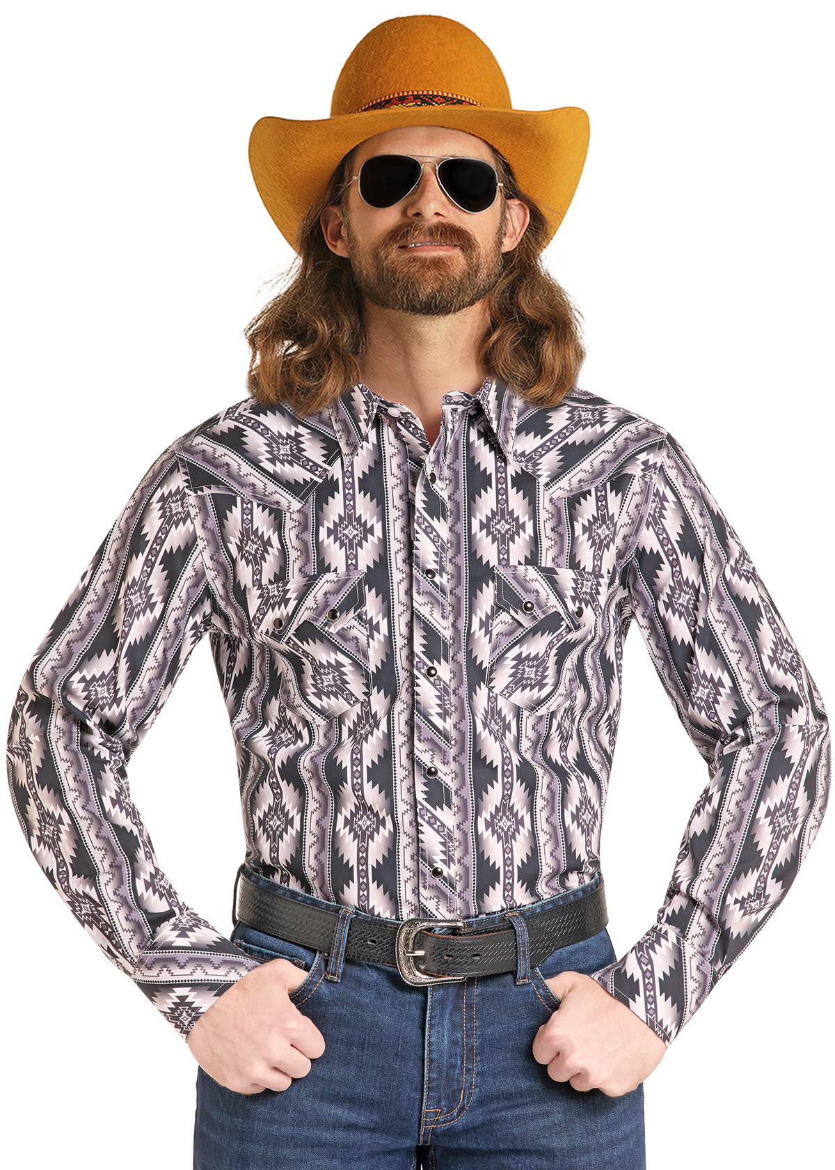 A man wearing a long-sleeve western-style button-up shirt with a gray, black, and white geometric Southwestern pattern, styled with a yellow-orange cowboy hat, sunglasses, a black belt, and blue jeans against a plain white background.