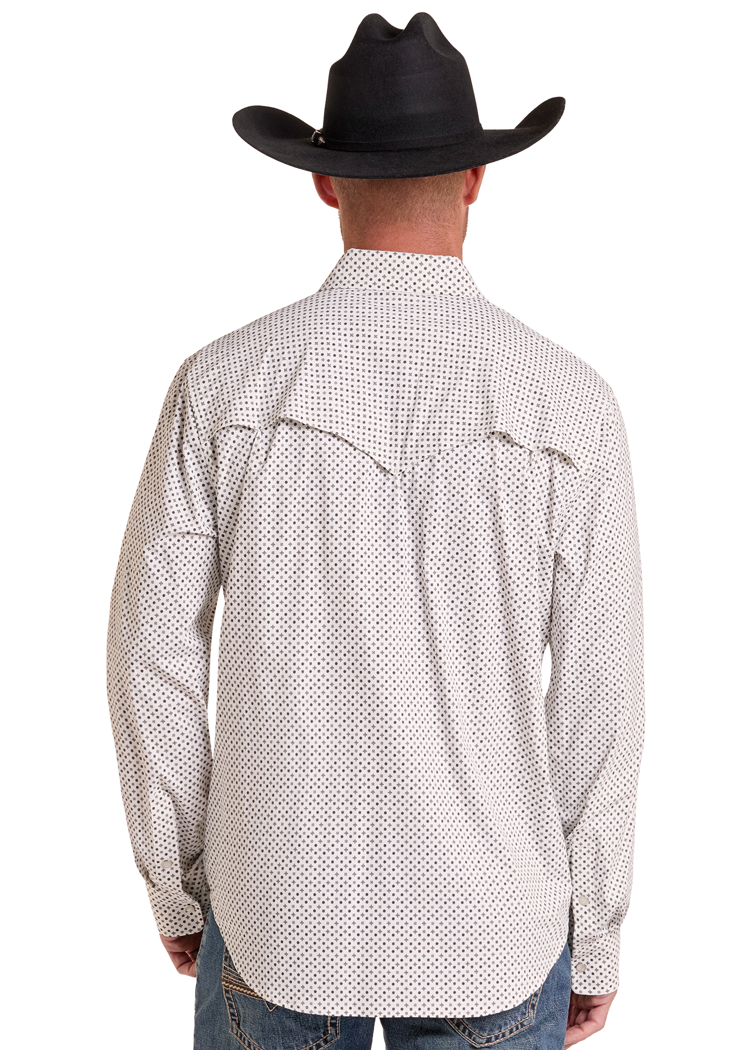A man viewed from the back wearing a black cowboy hat, a white long-sleeve button-up shirt with a small black geometric pattern, and blue jeans against a plain white background.