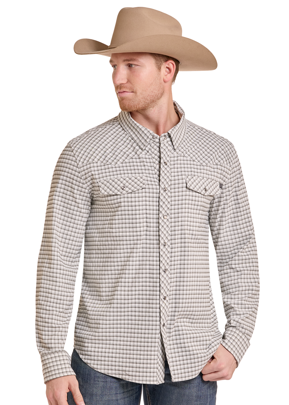 A man wearing a tan cowboy hat and a beige and brown checkered western long-sleeve button-down shirt, paired with blue jeans, photographed against a solid white background.