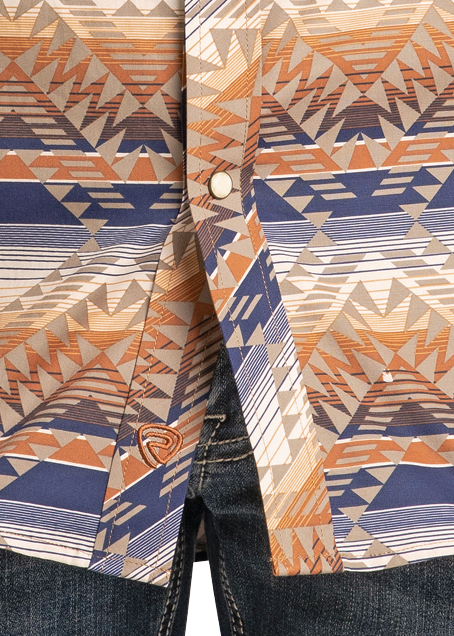 Close-up of a patterned shirt with geometric design in blue, orange, and beige.