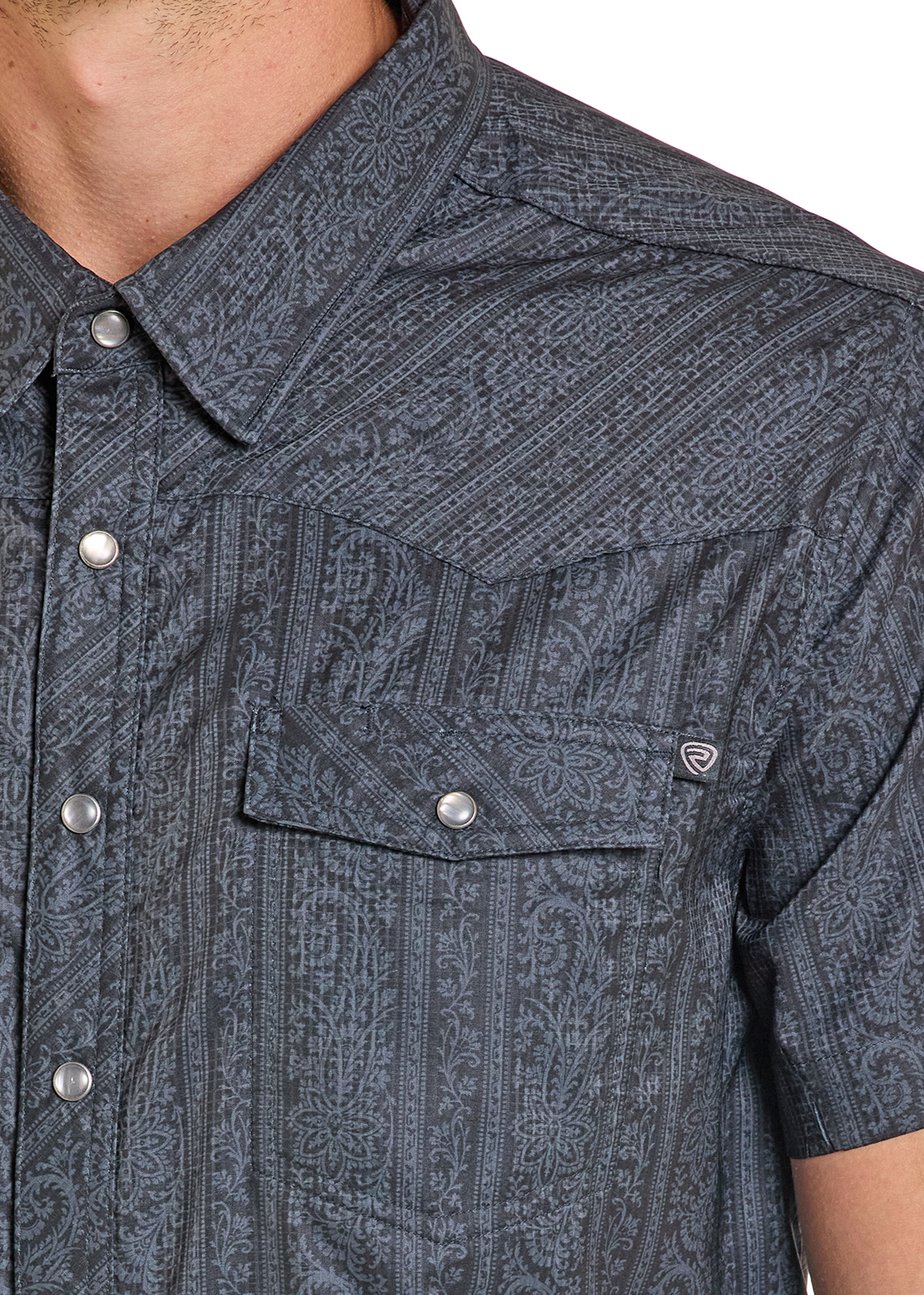 Close-up of a patterned short-sleeve shirt with button details.